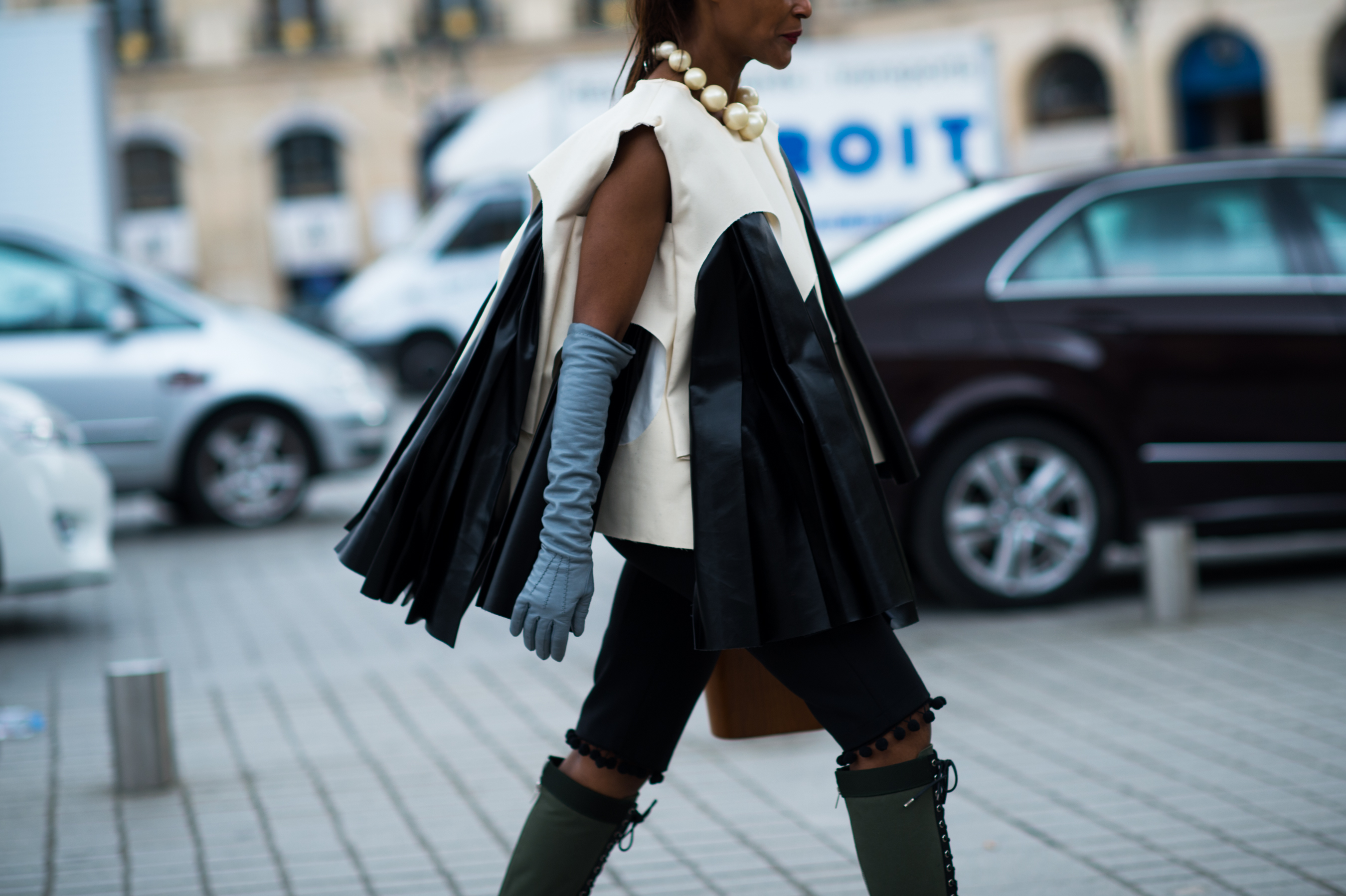 Woman wearing leather outfit with big pearl necklace