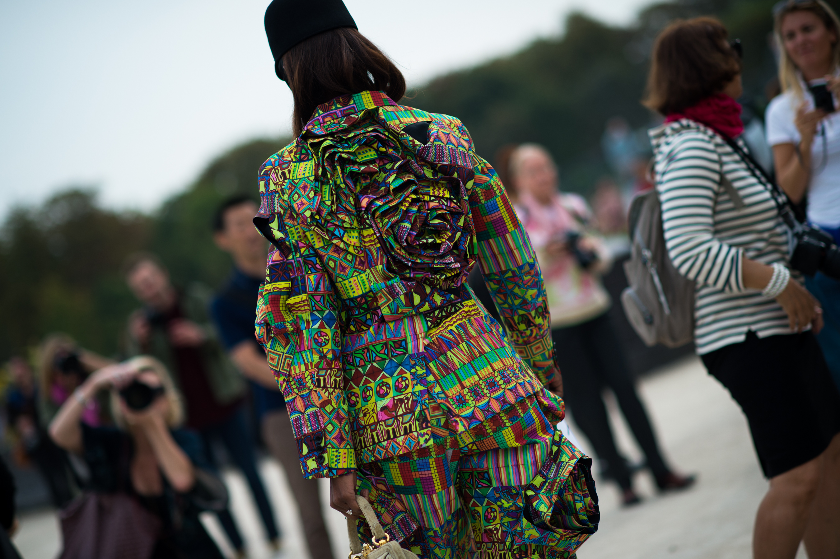 Woman wearing complex colourful outfit