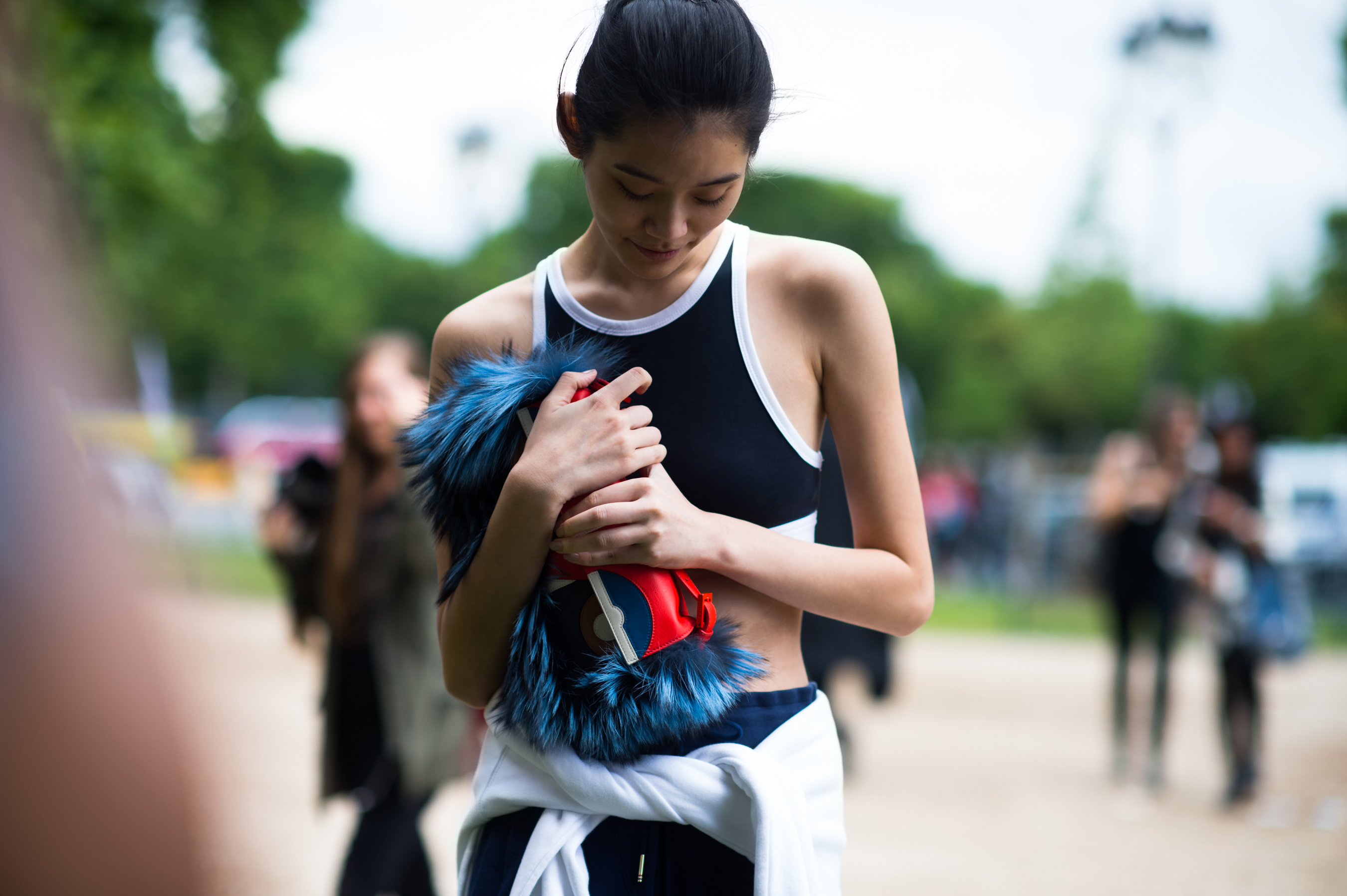Chinese model wearing short top and furry bag