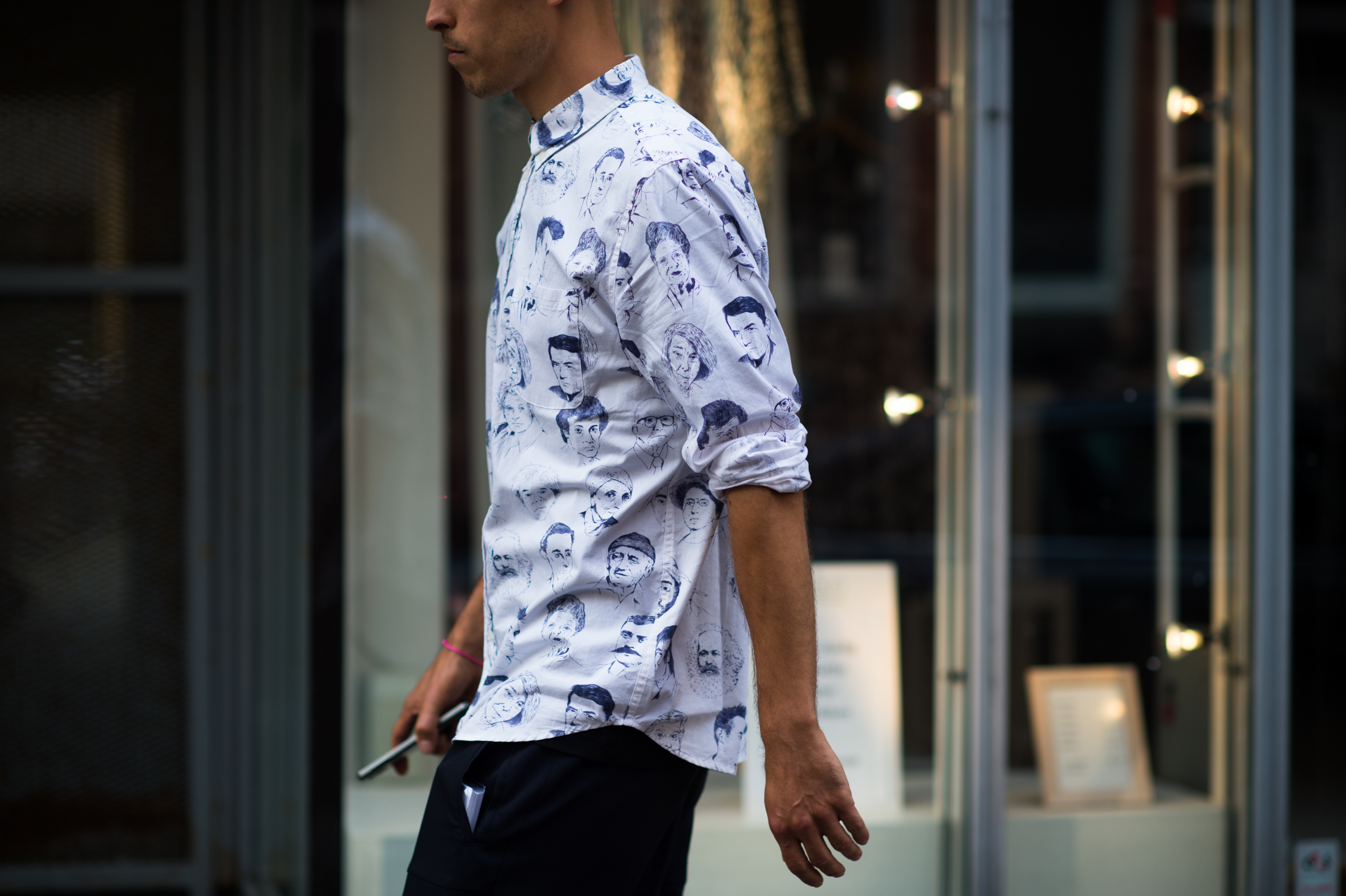 Man wearing shirt with faces