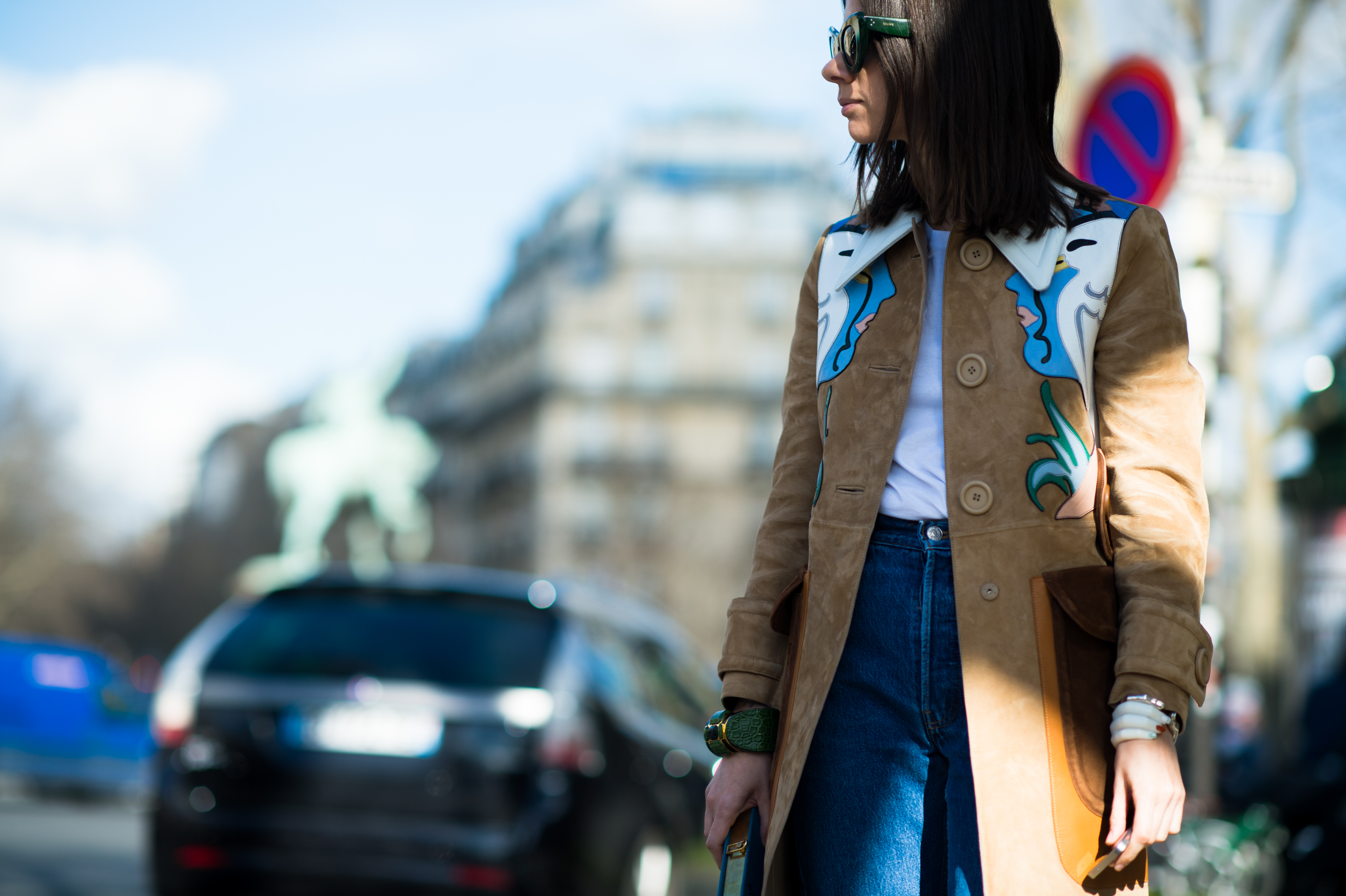 Russian buyer wearing suede coat with faces