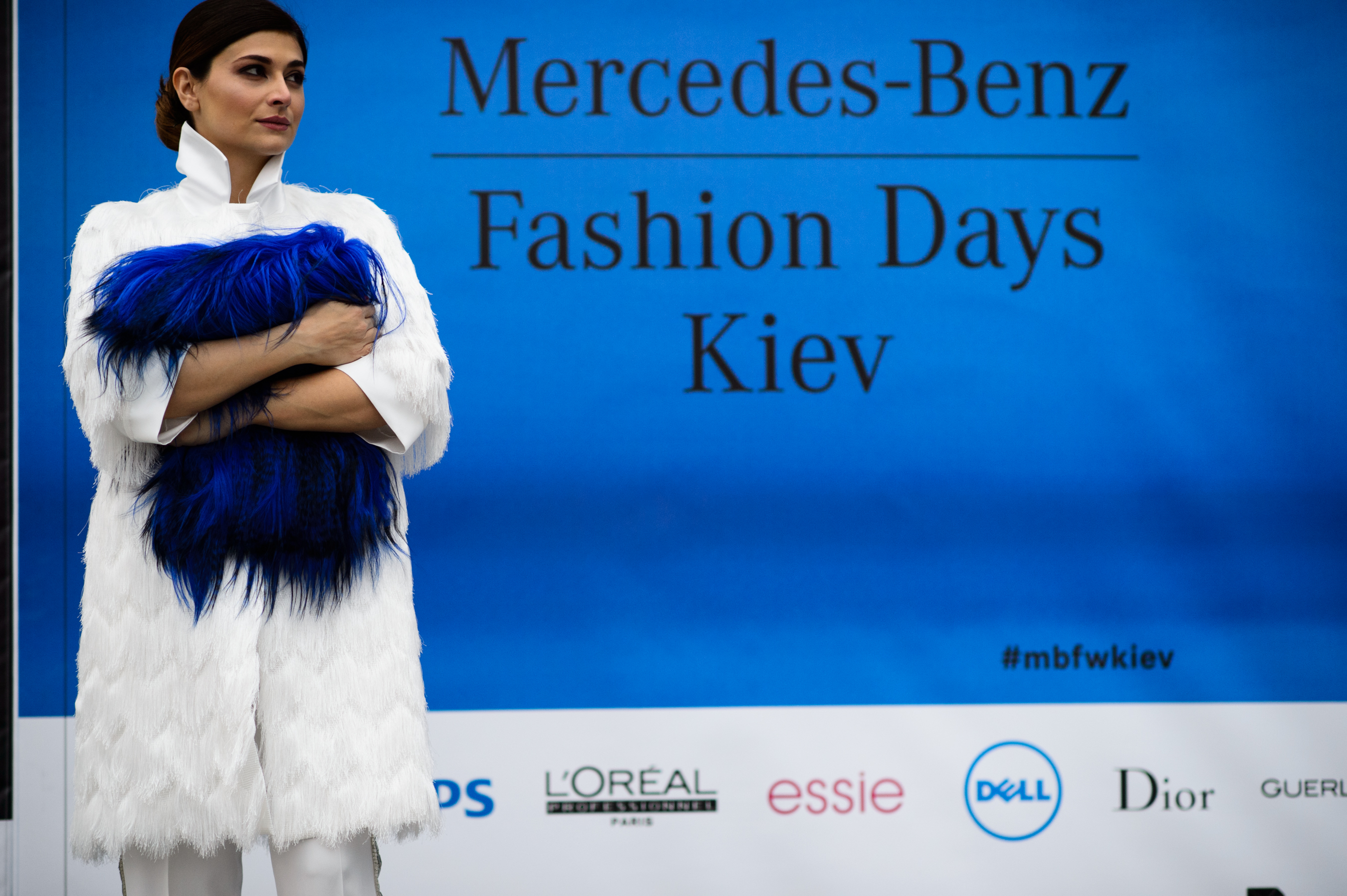 Fashion week founder next to advert
