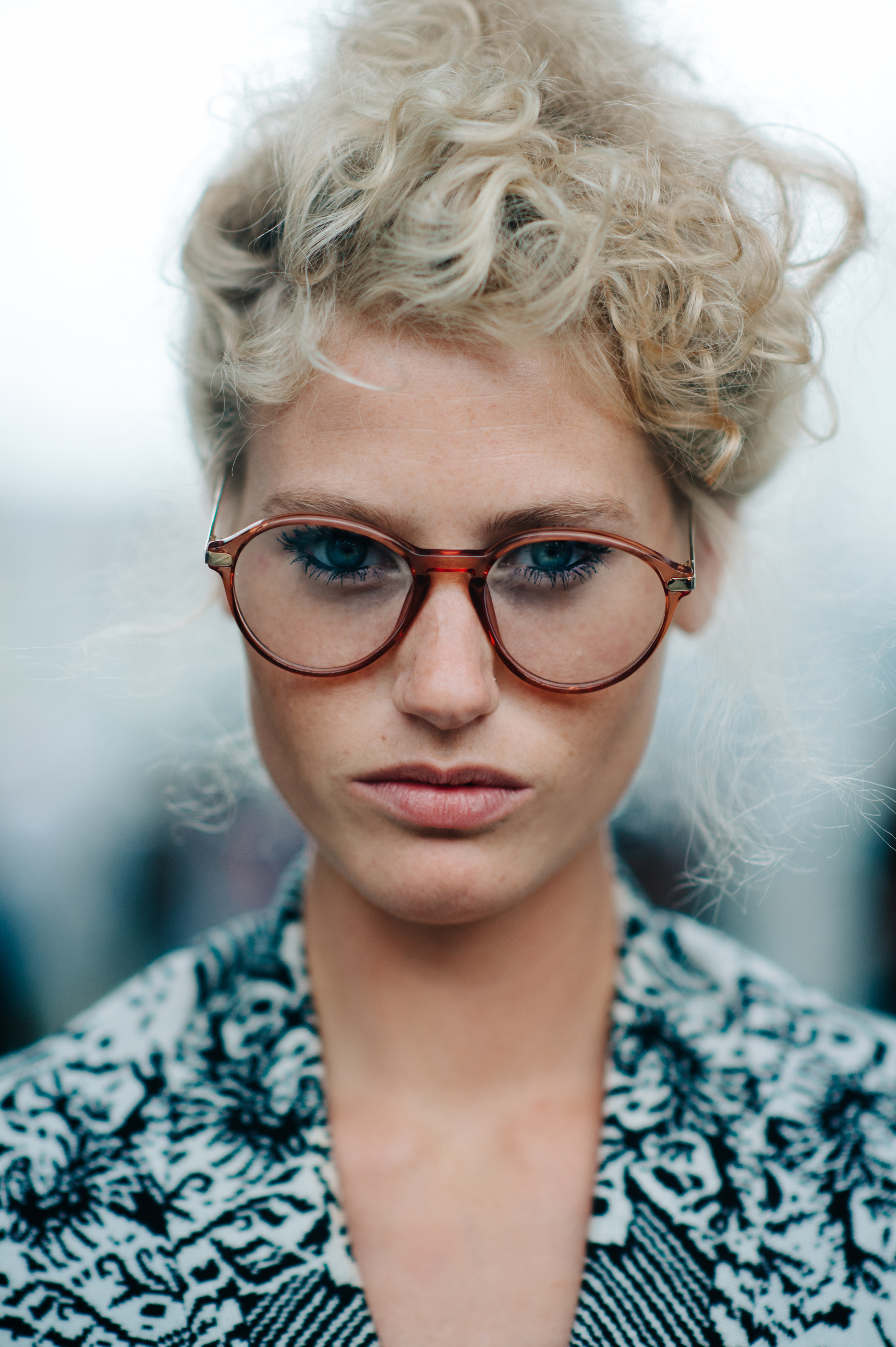 Portrait of a girl with white curly hair and glasses