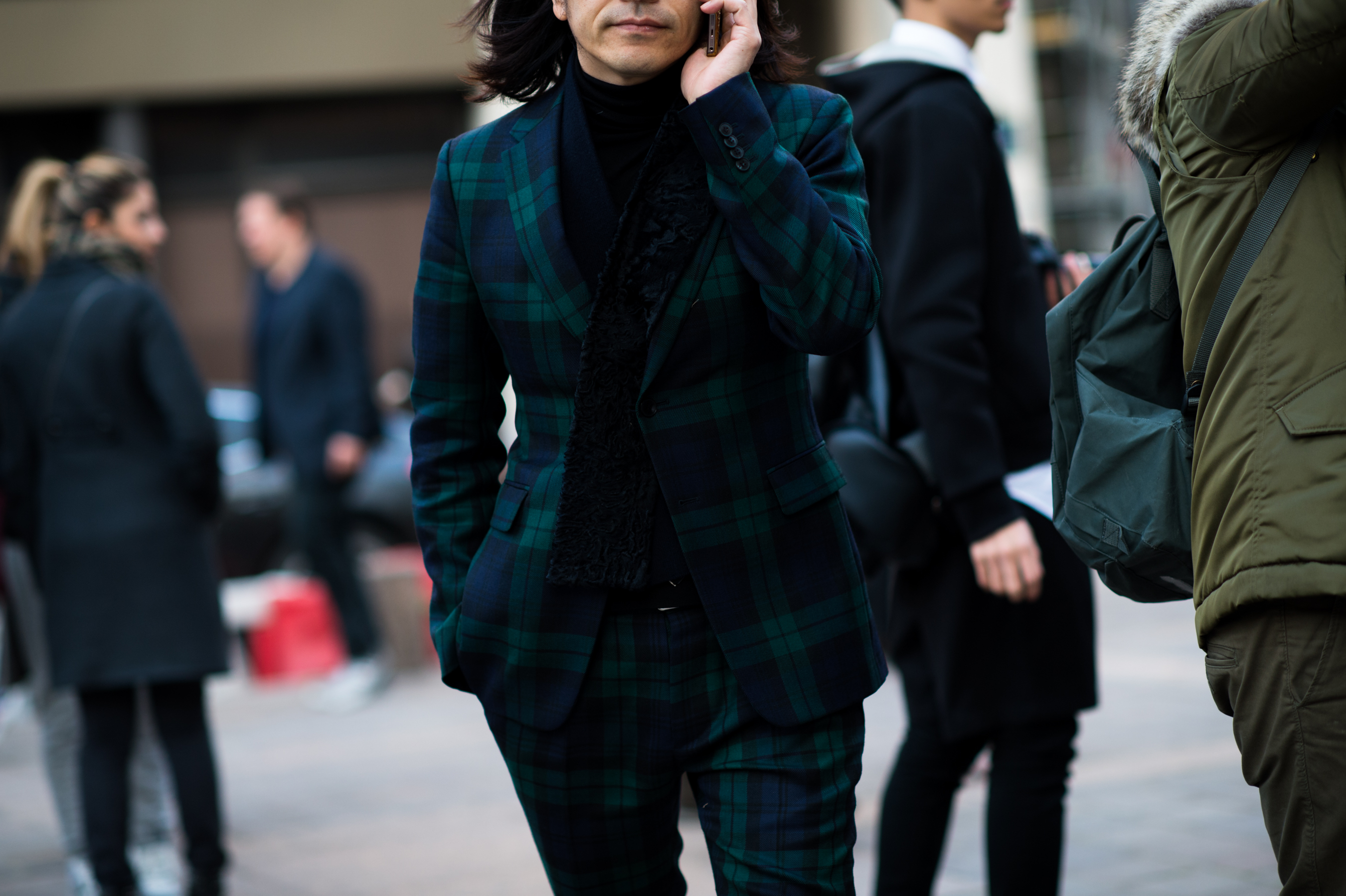 Man wearing green and blue suit