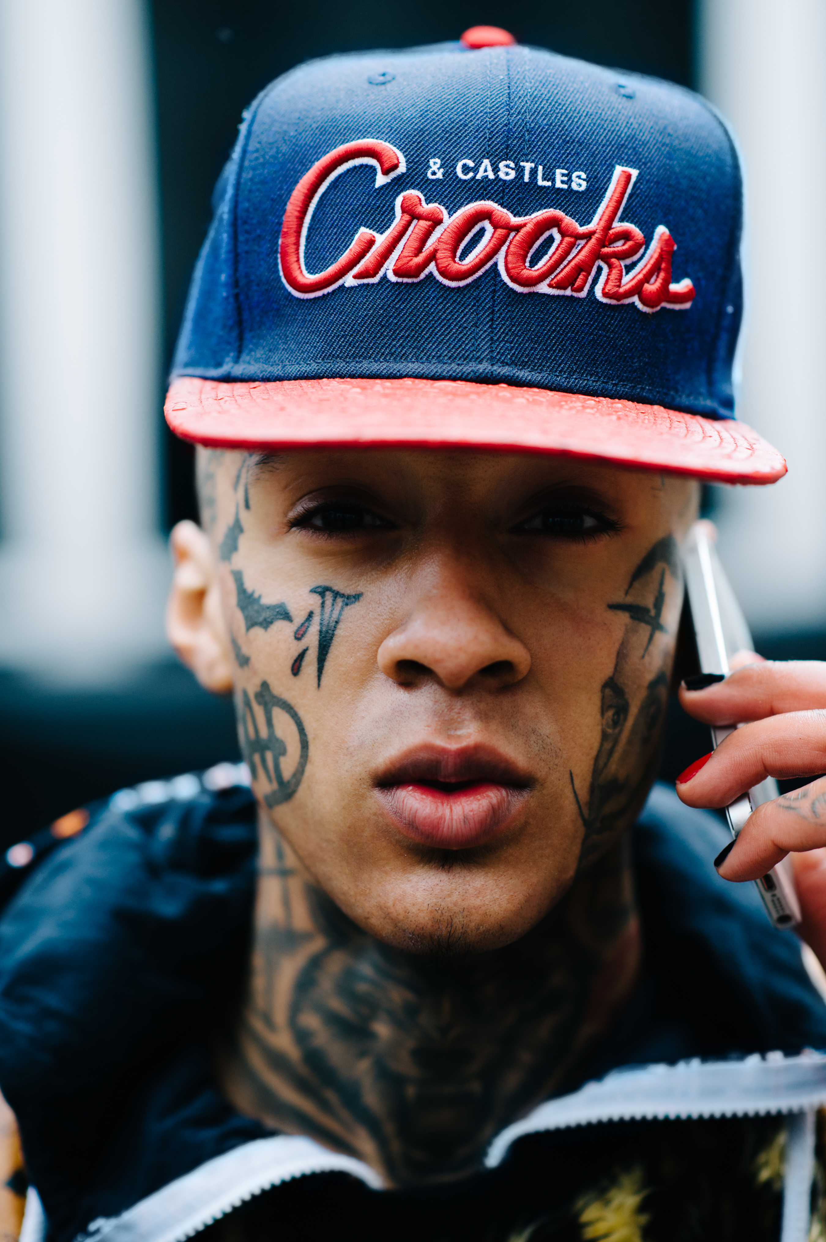 Portrait of a British rapped with tattoos on face