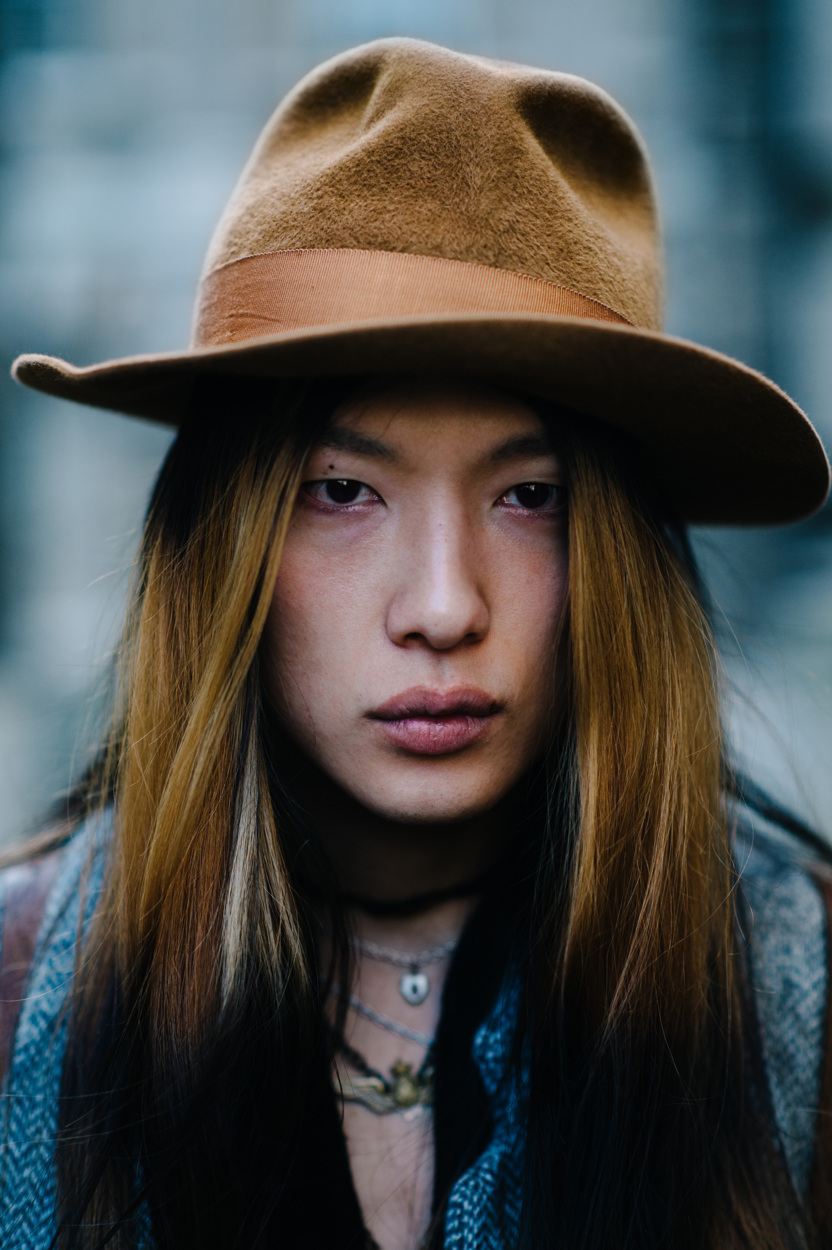 Portrait of a man with long hair and brown hat