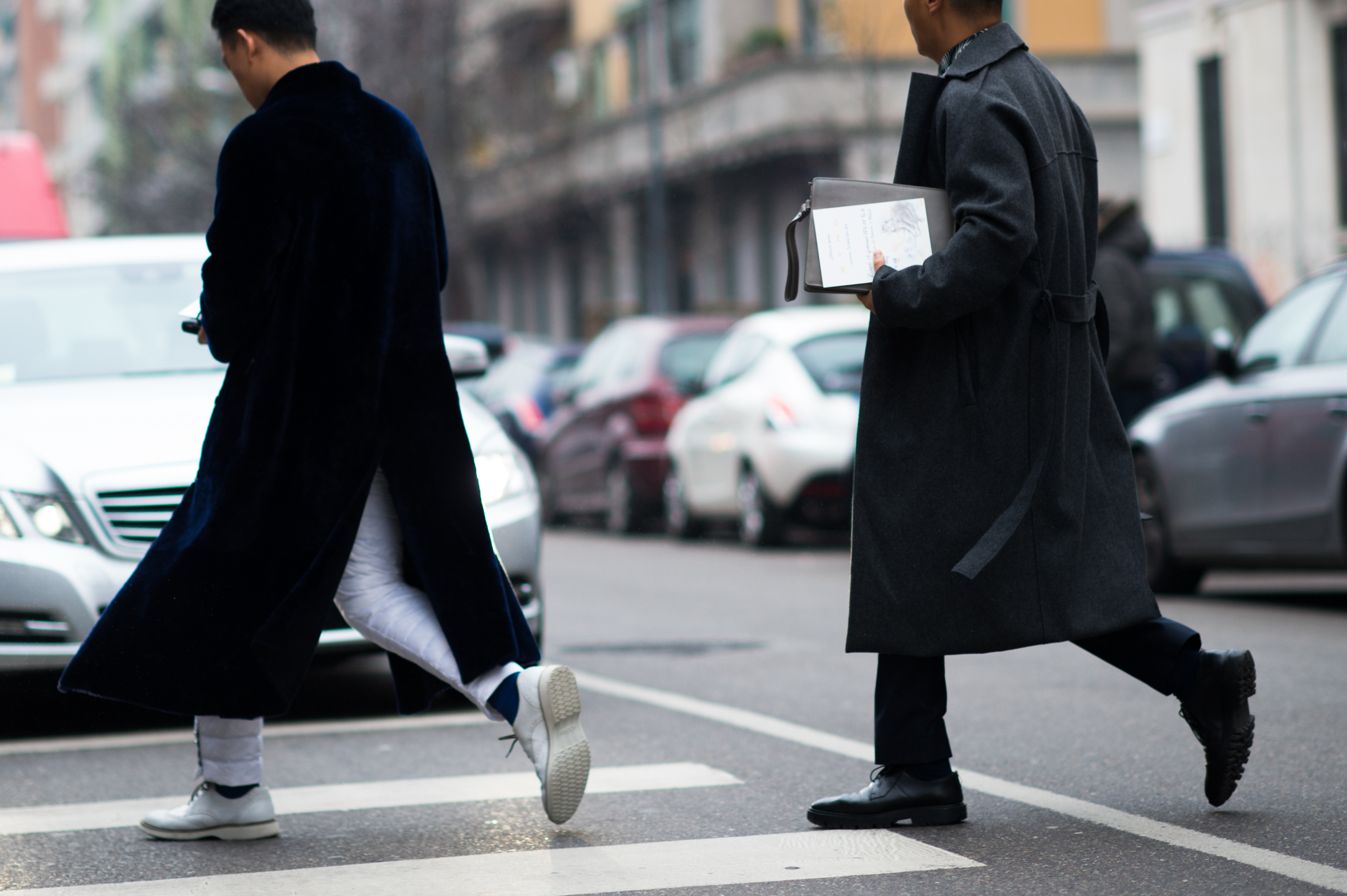Two men wearing coats
