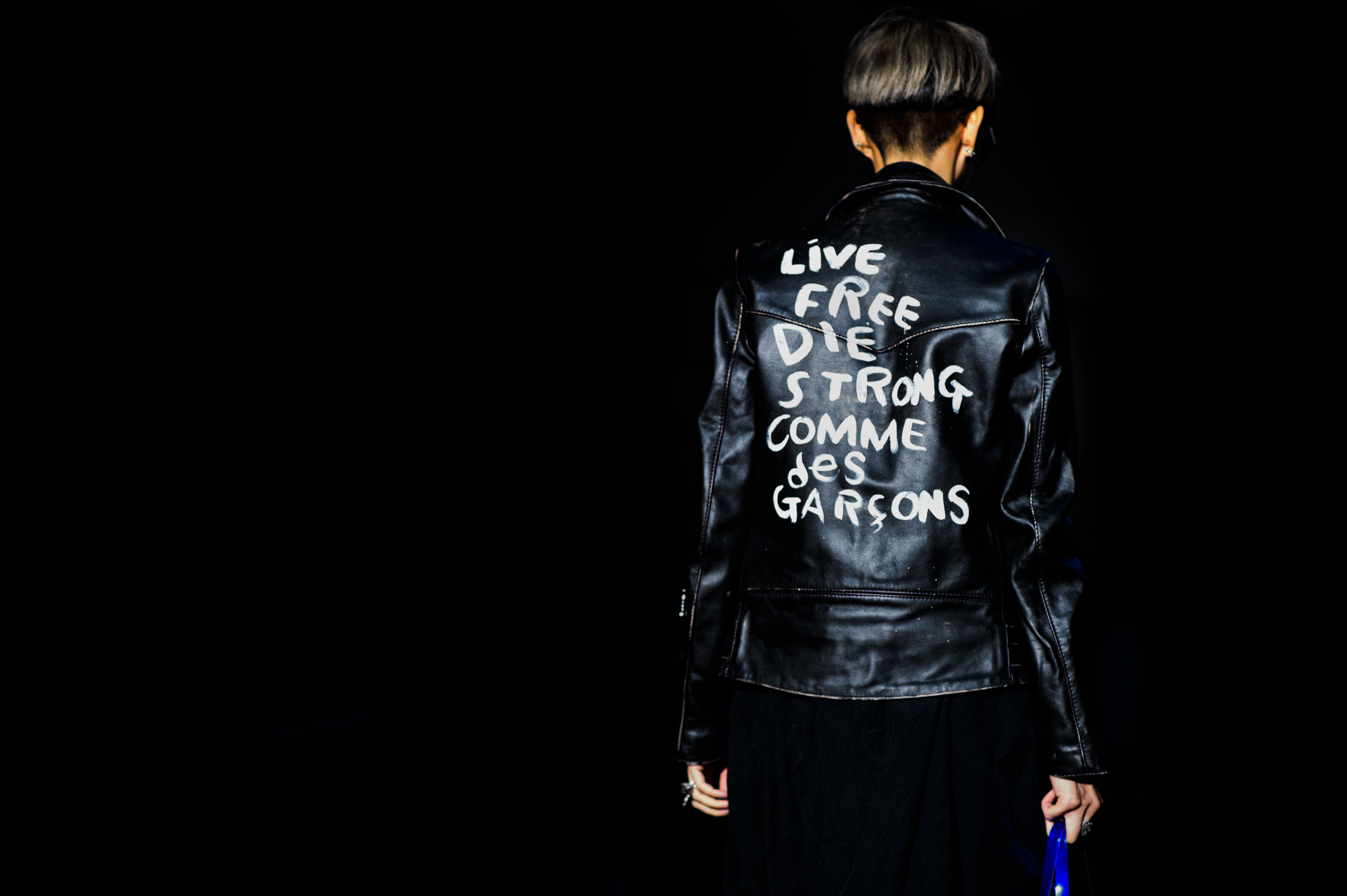 Woman wearing leather jacket by Japanese designer