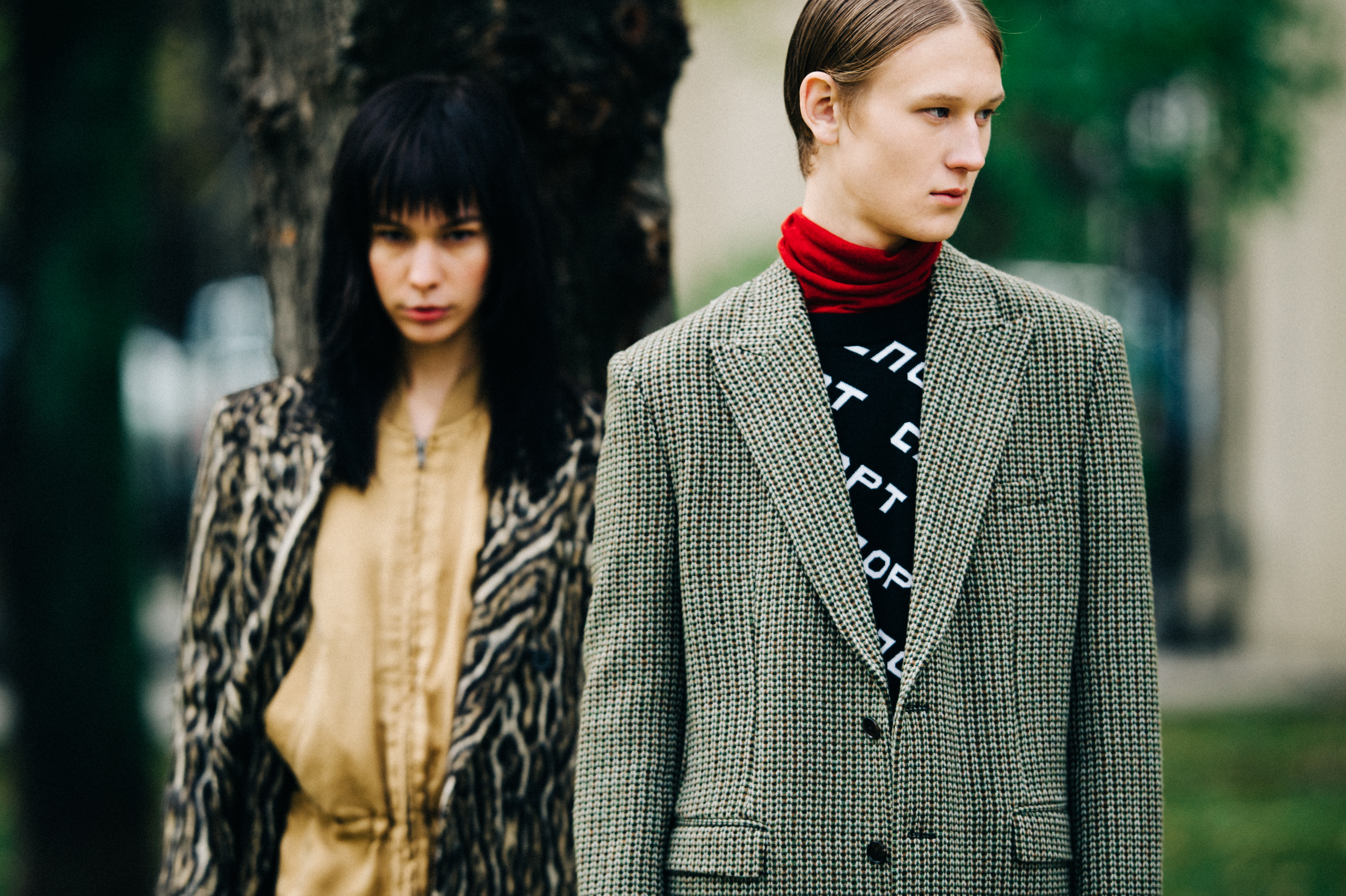Two model posing in coats
