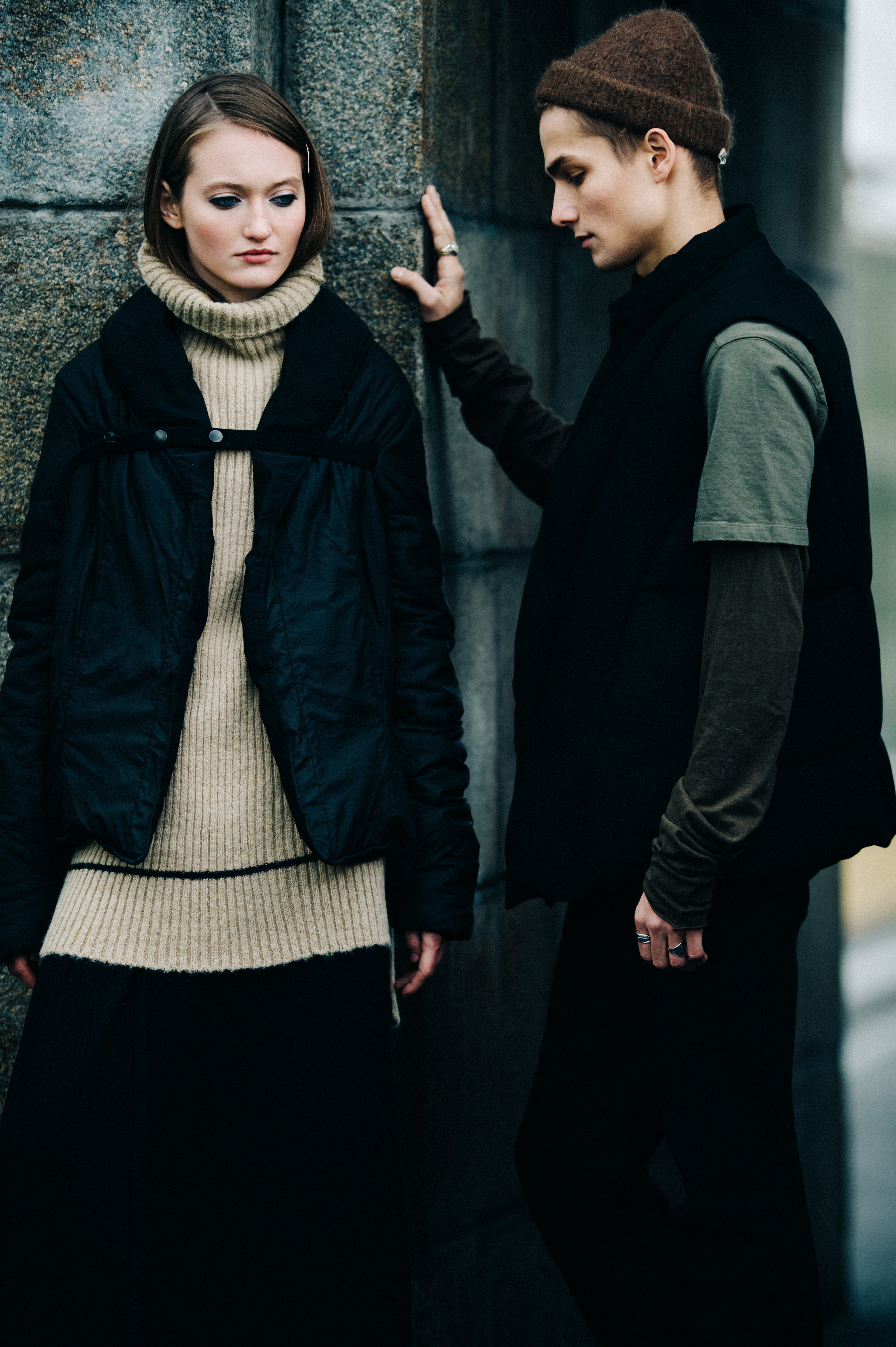 Two models wearing dark clothes