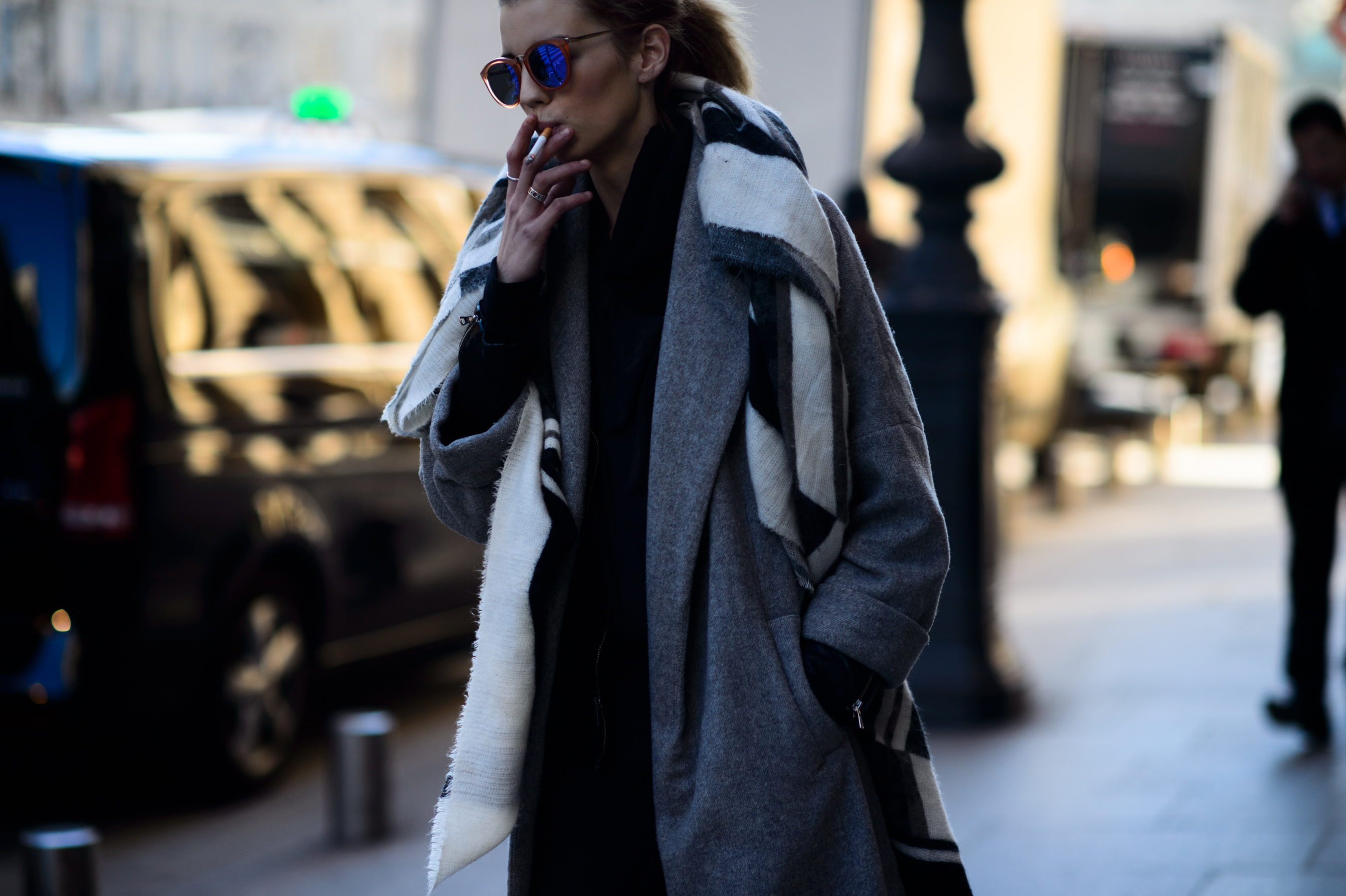 Model wearing glasses smoking