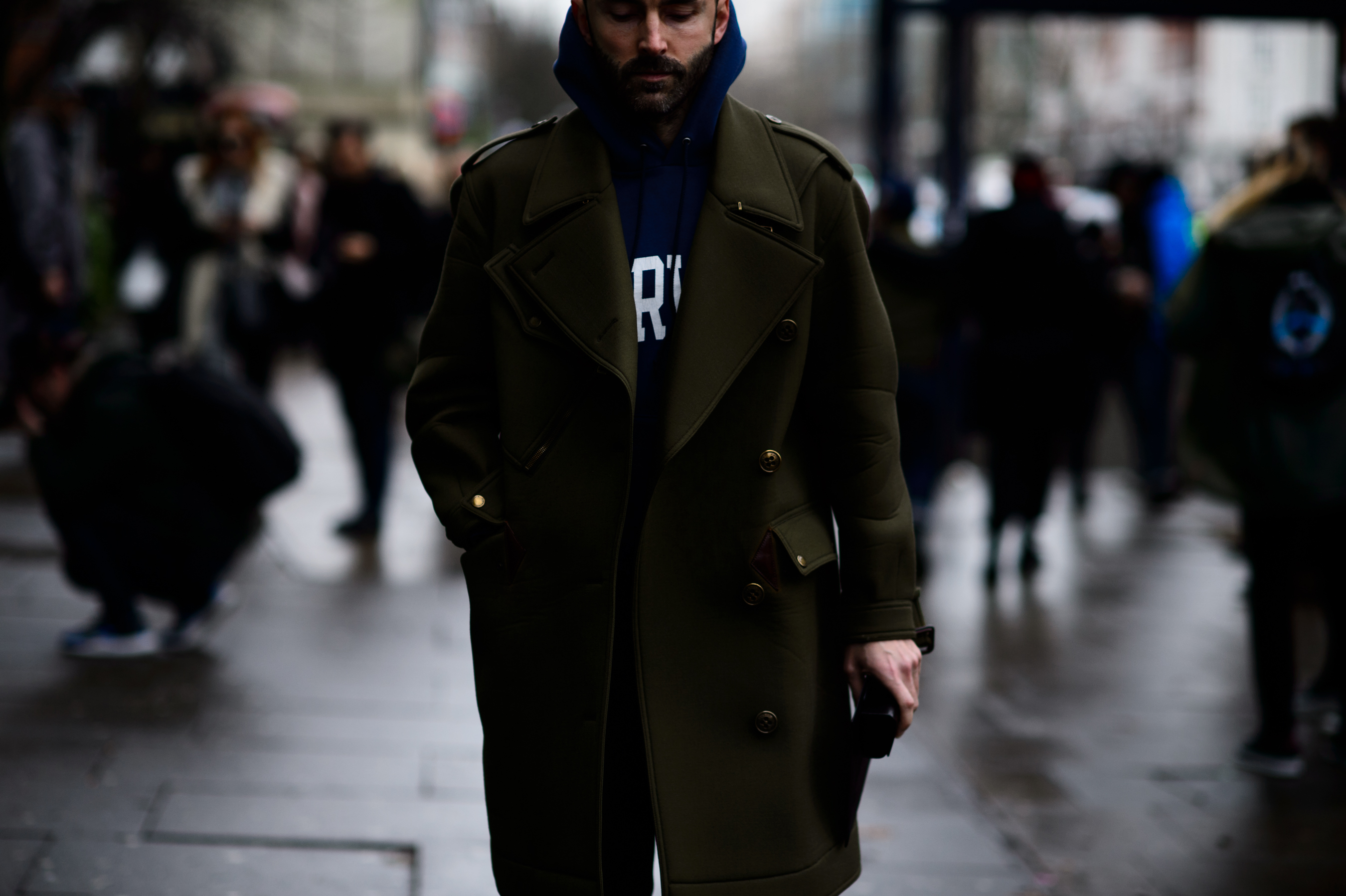 Man wearing green coat and hoodie