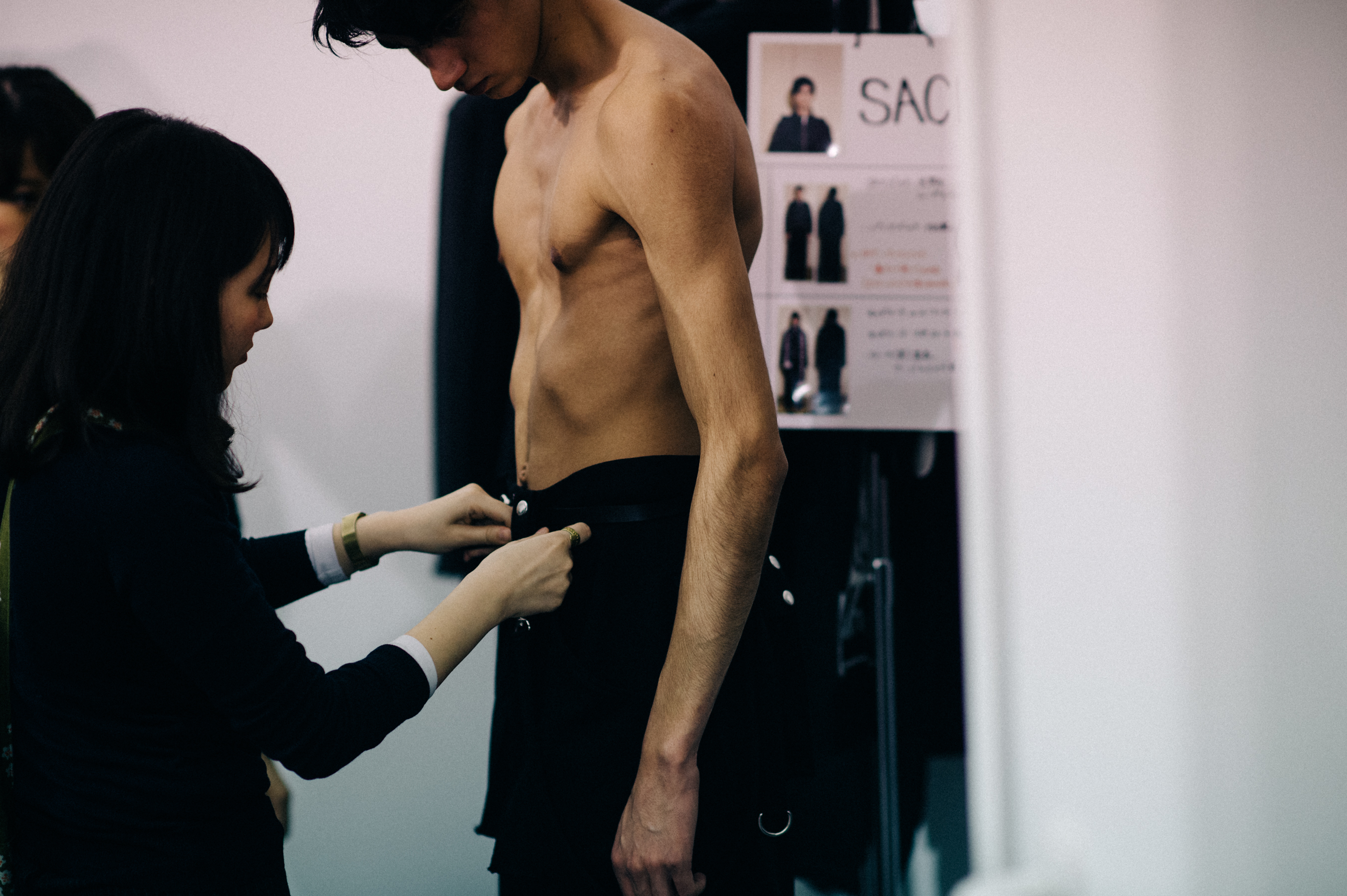 Male model getting dressed