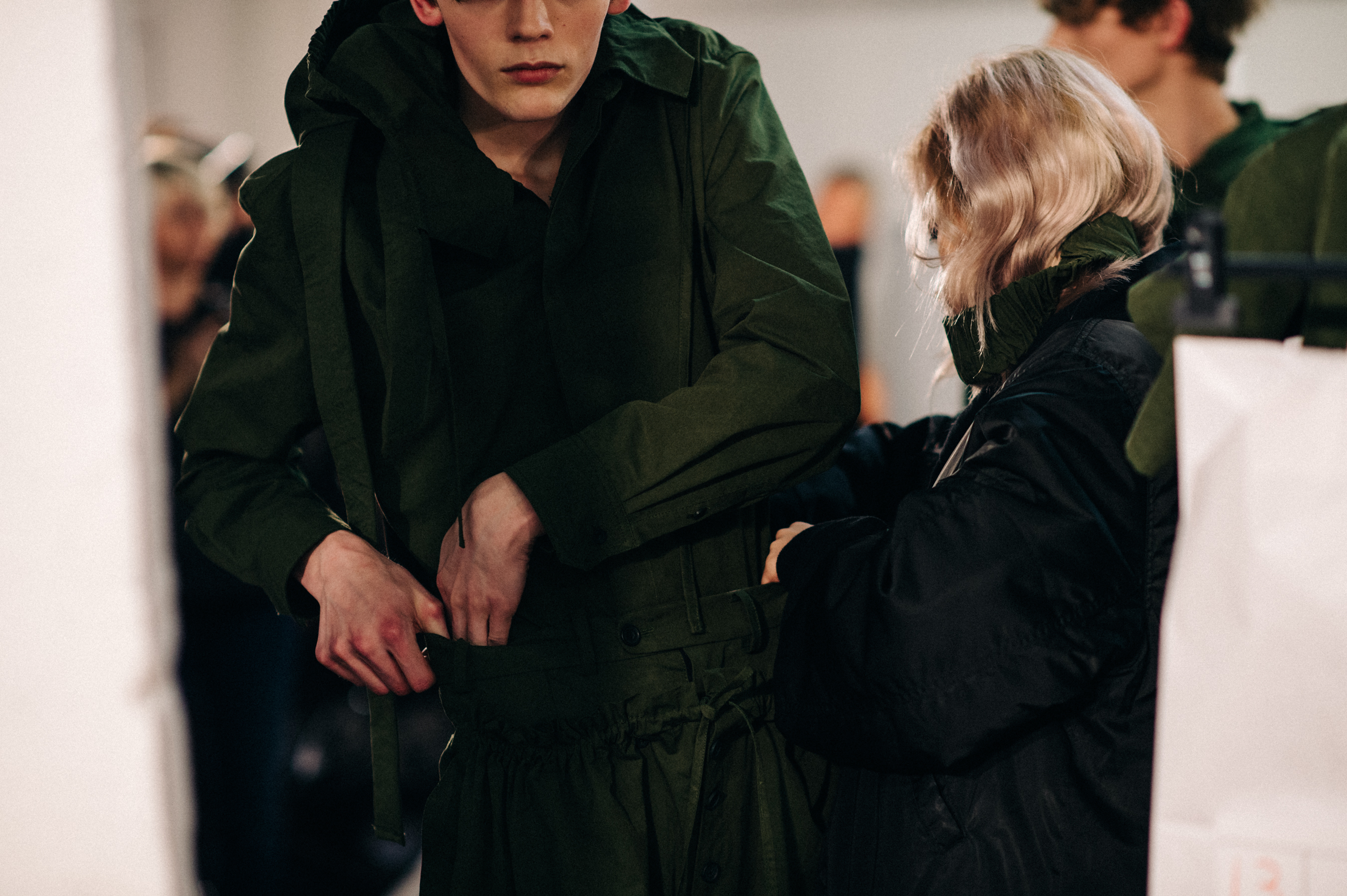 Male model wearing green before the show