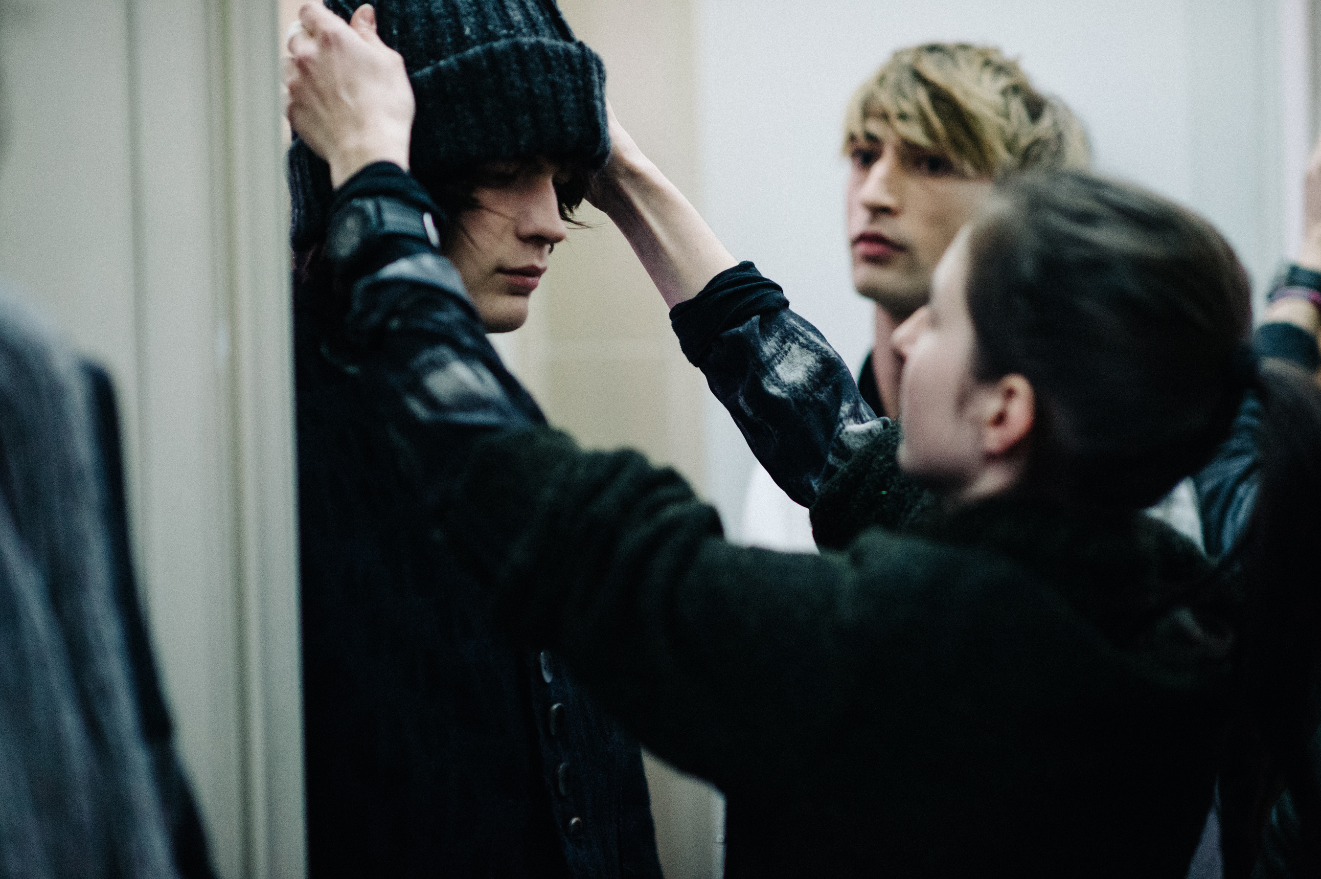 Male model getting hat put on