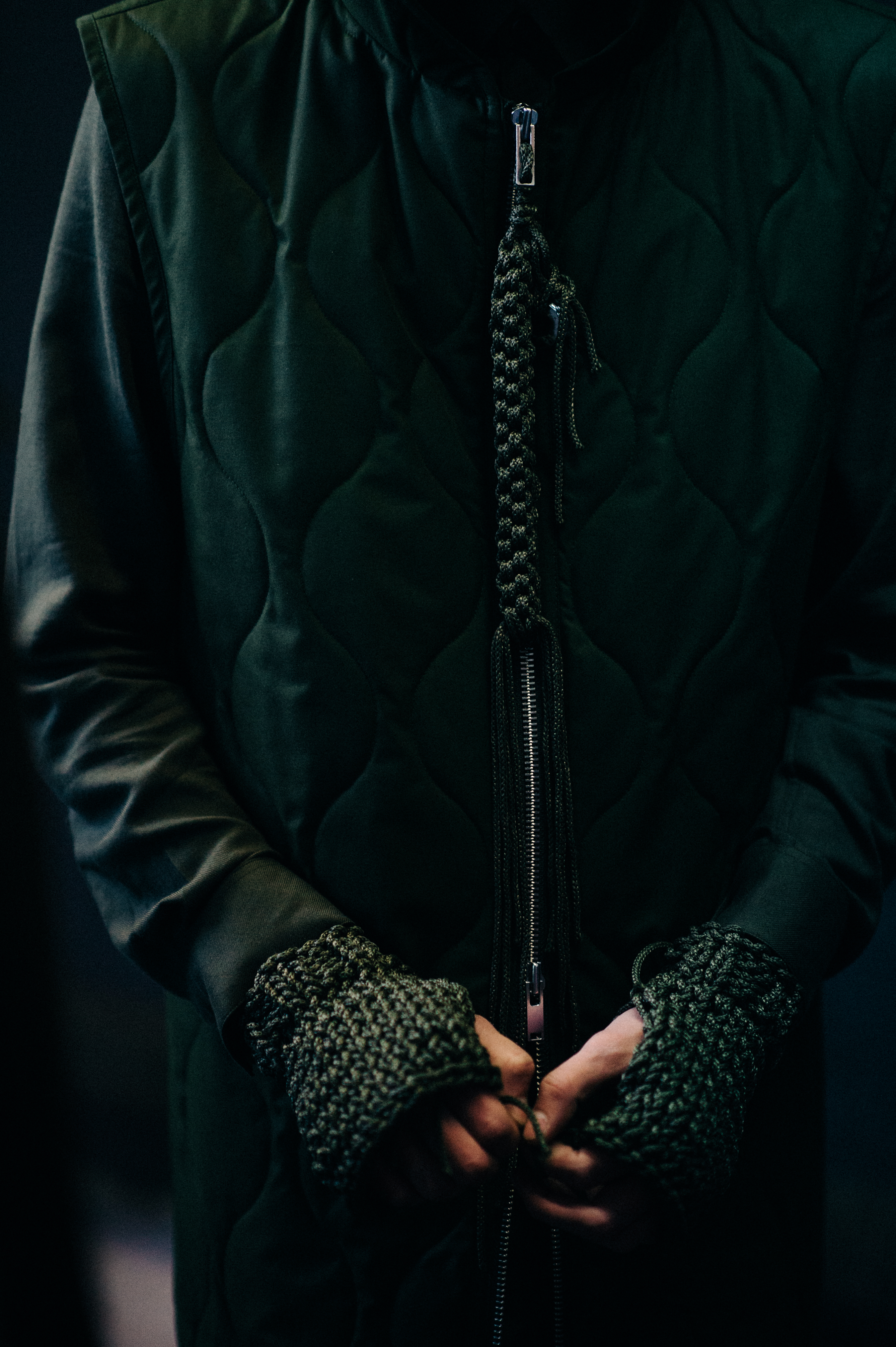 Model zipping green jacket