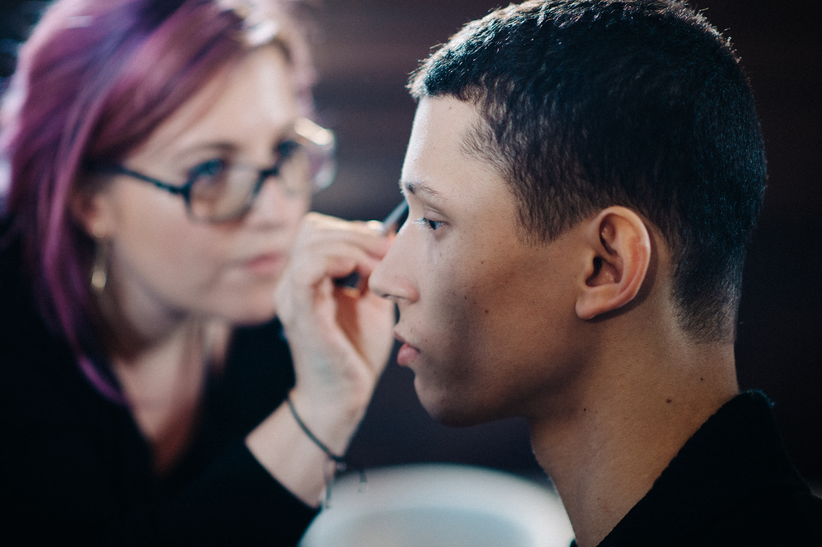 Male model getting make up done