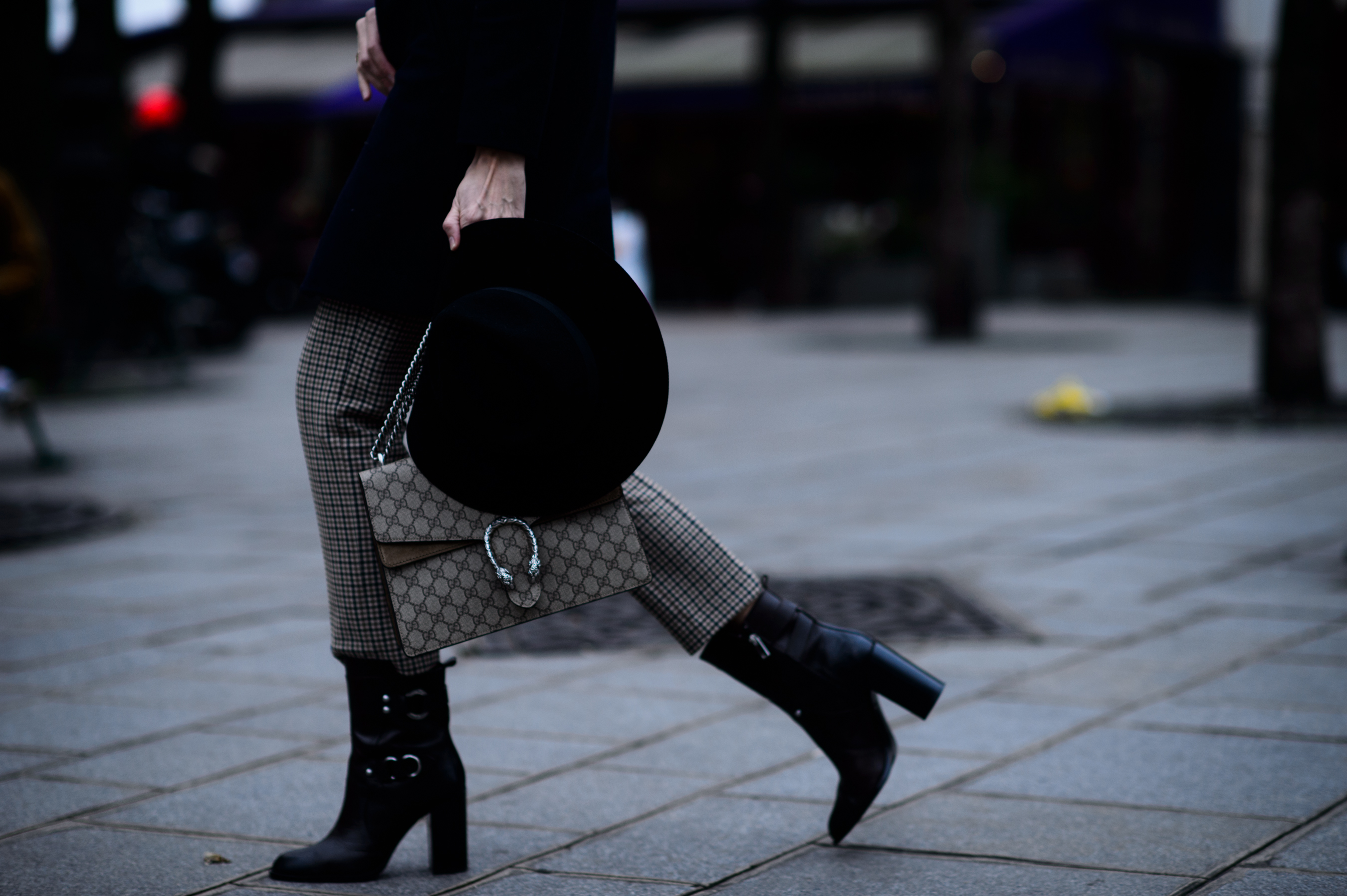 Close up of high boots gucci bag