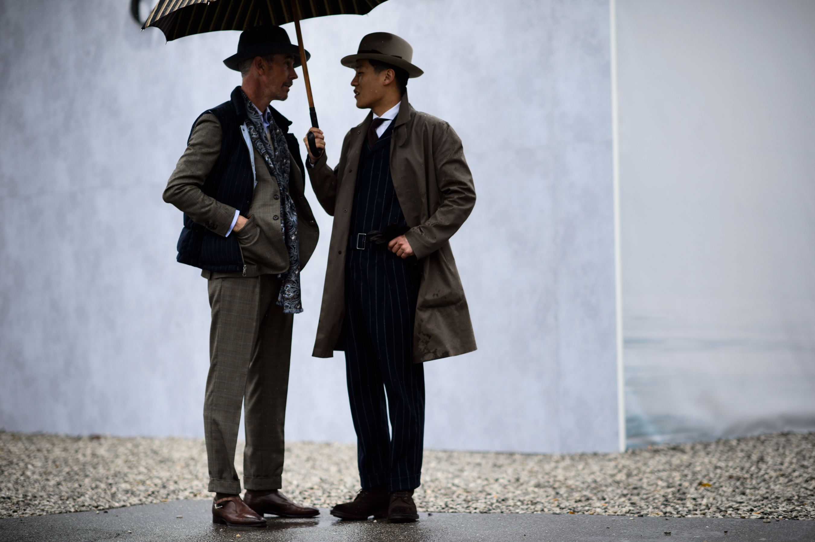 Two men wearing brown suits