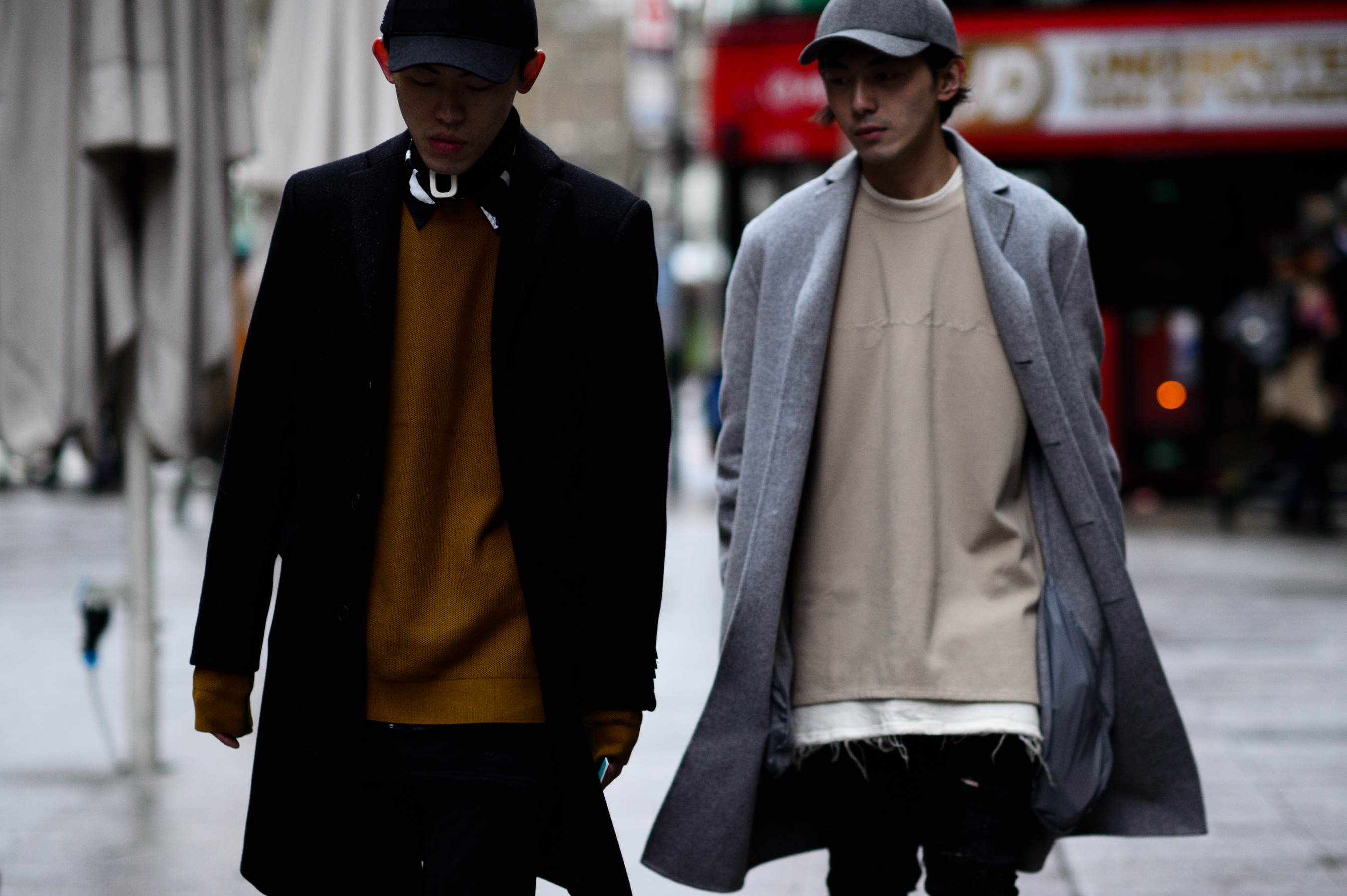 Two designers wearing black coats
