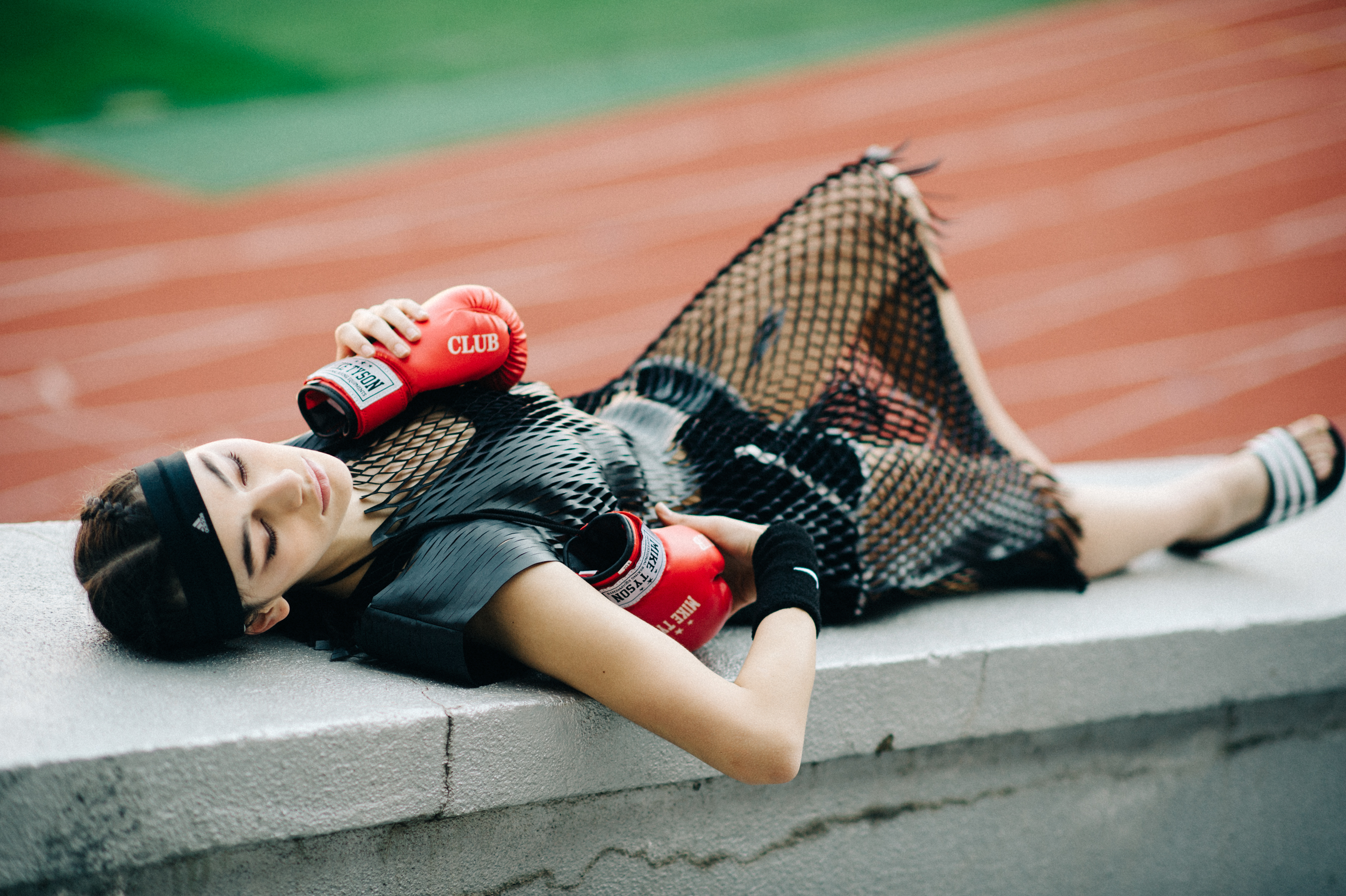 Model lying with boxing gloves