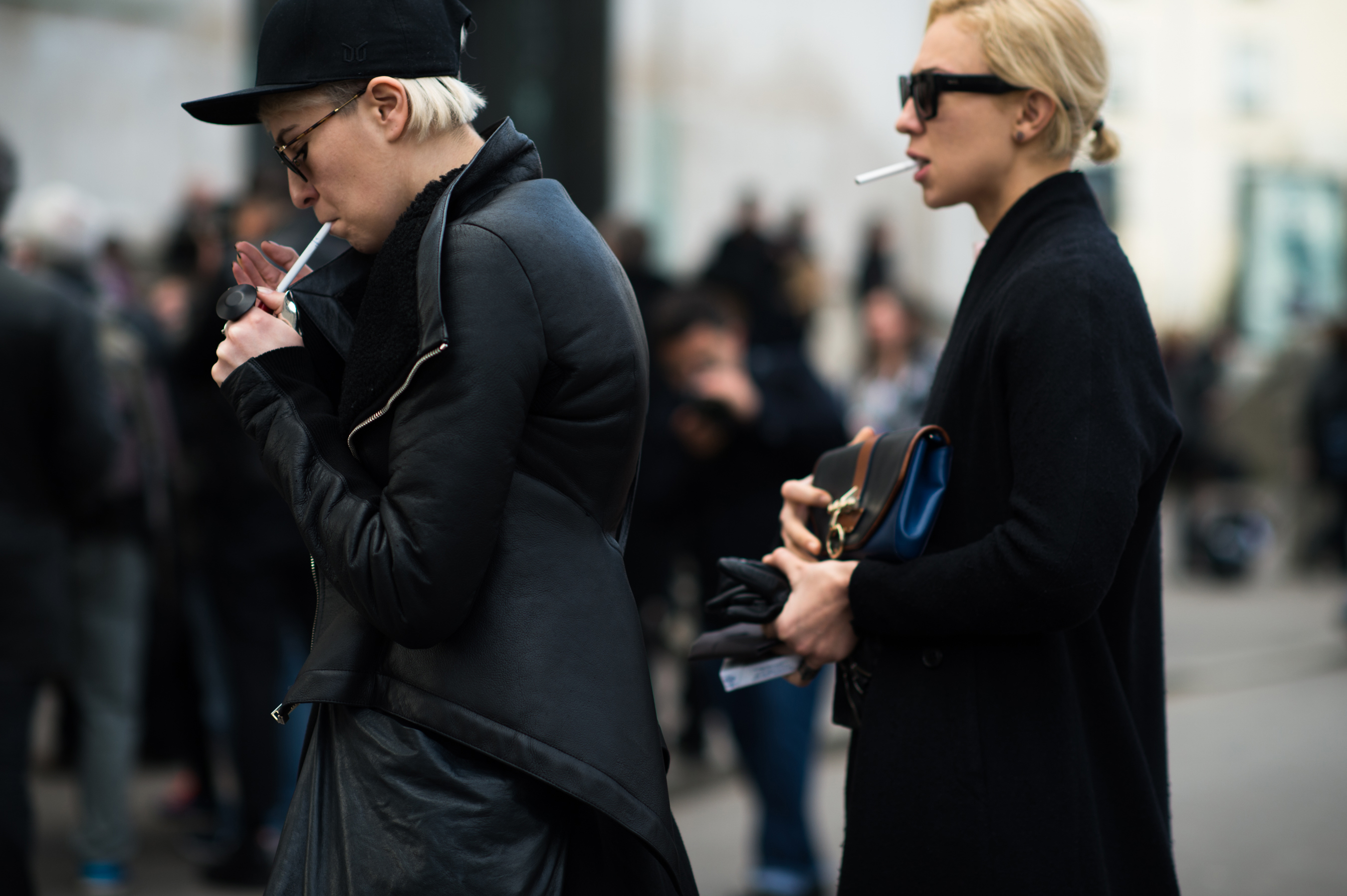 Two women with short hair smoking