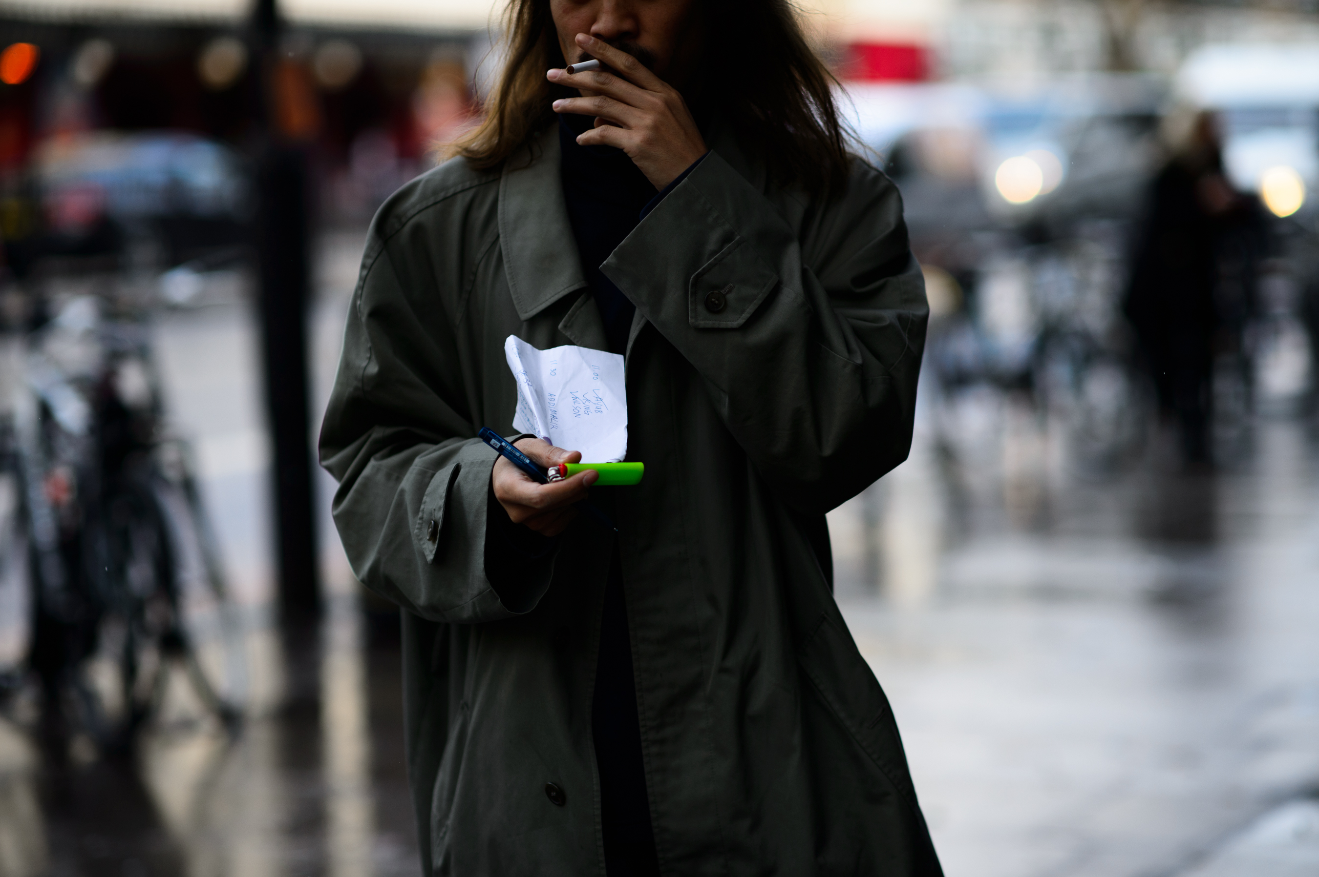 Man with long hair wearing coat