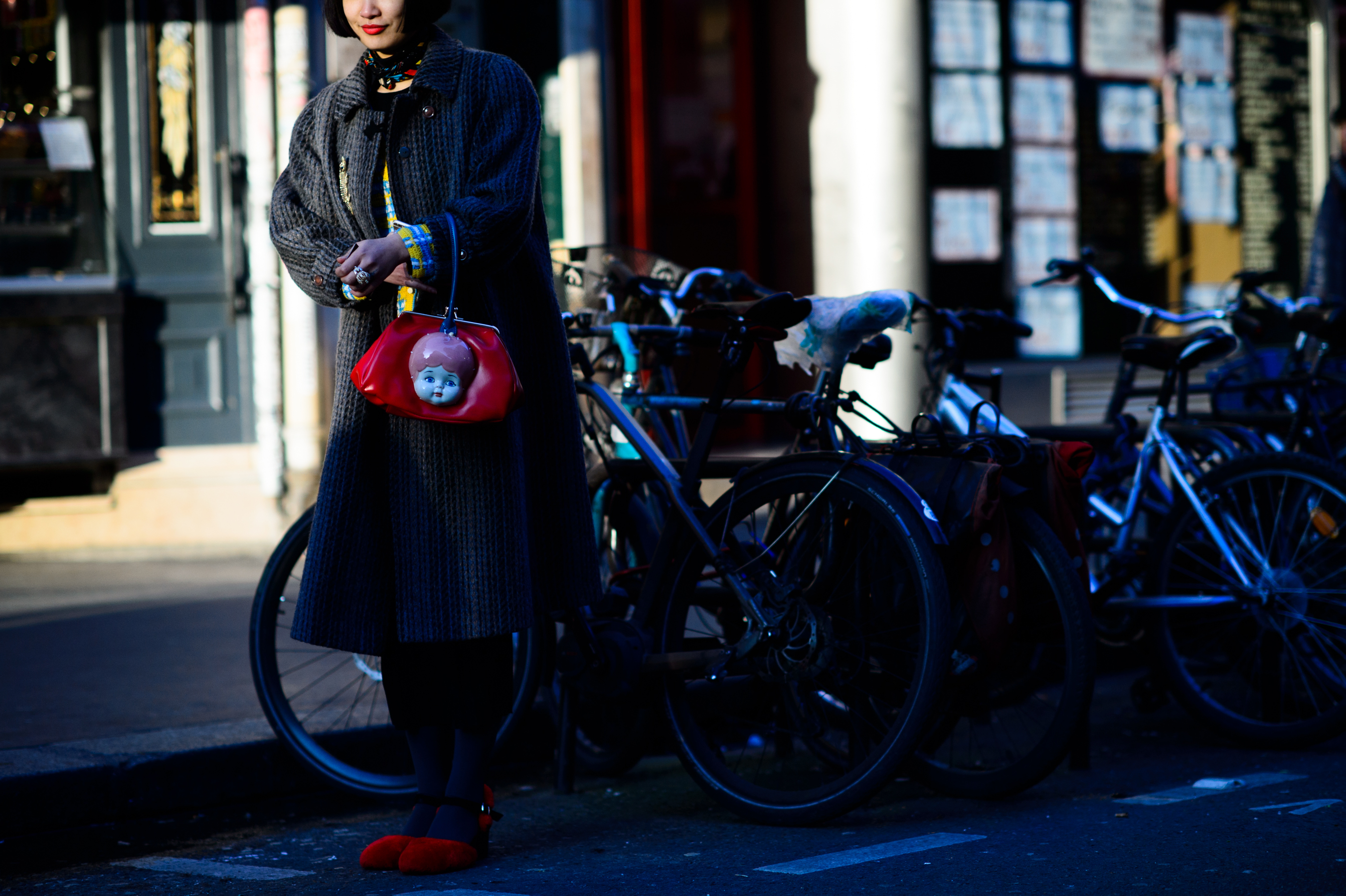 Woman holding bag doll face