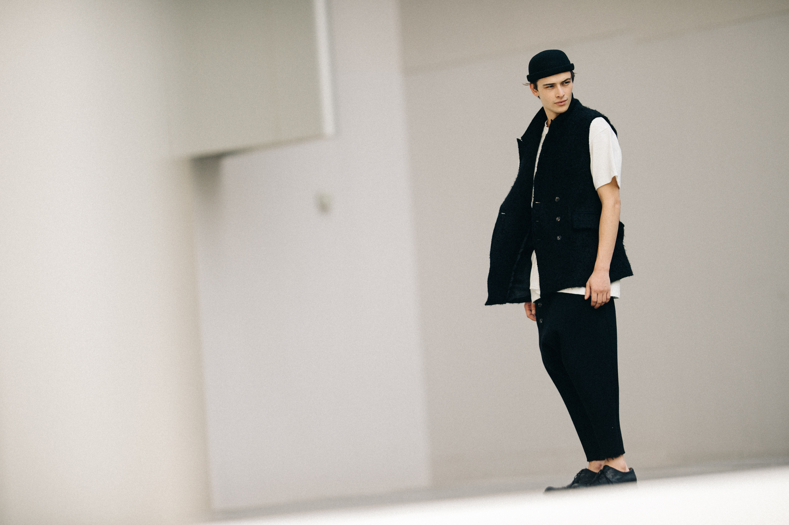 Male model wearing black and white outfit
