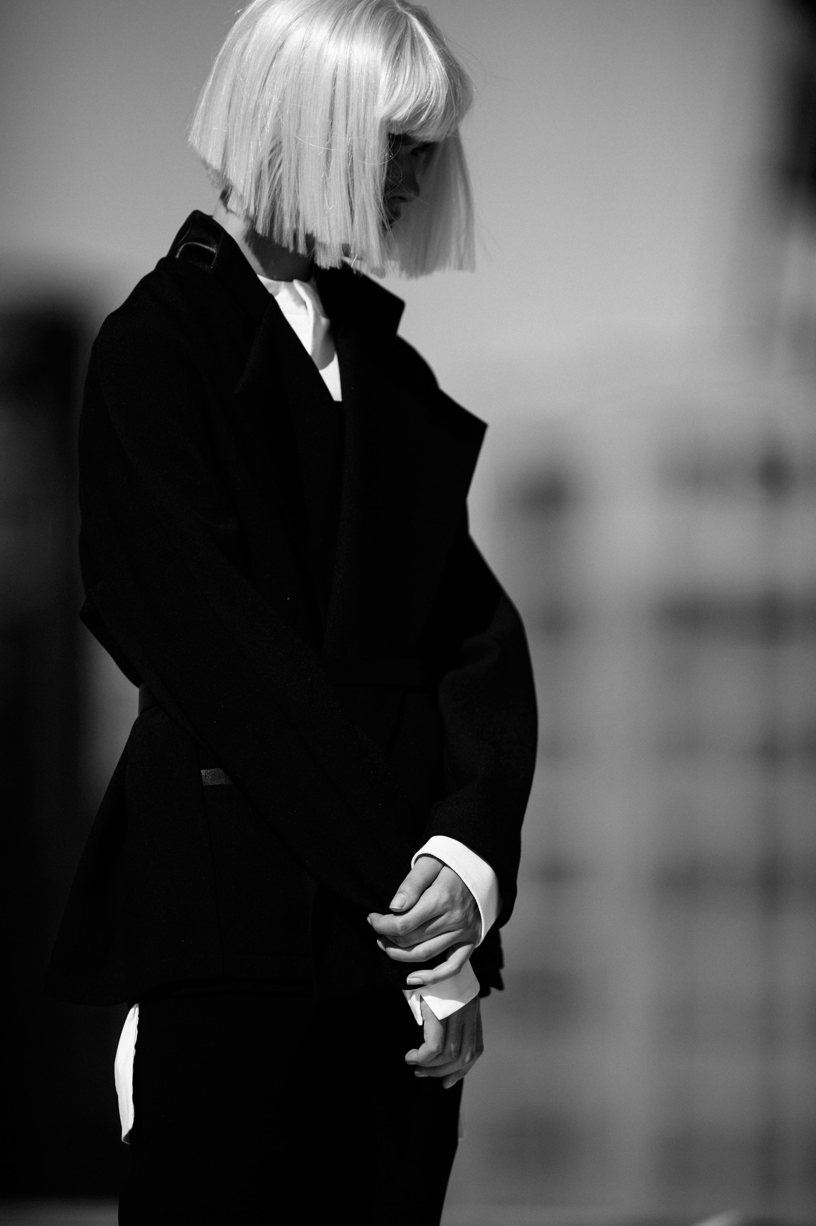 Model with white hair wearing black