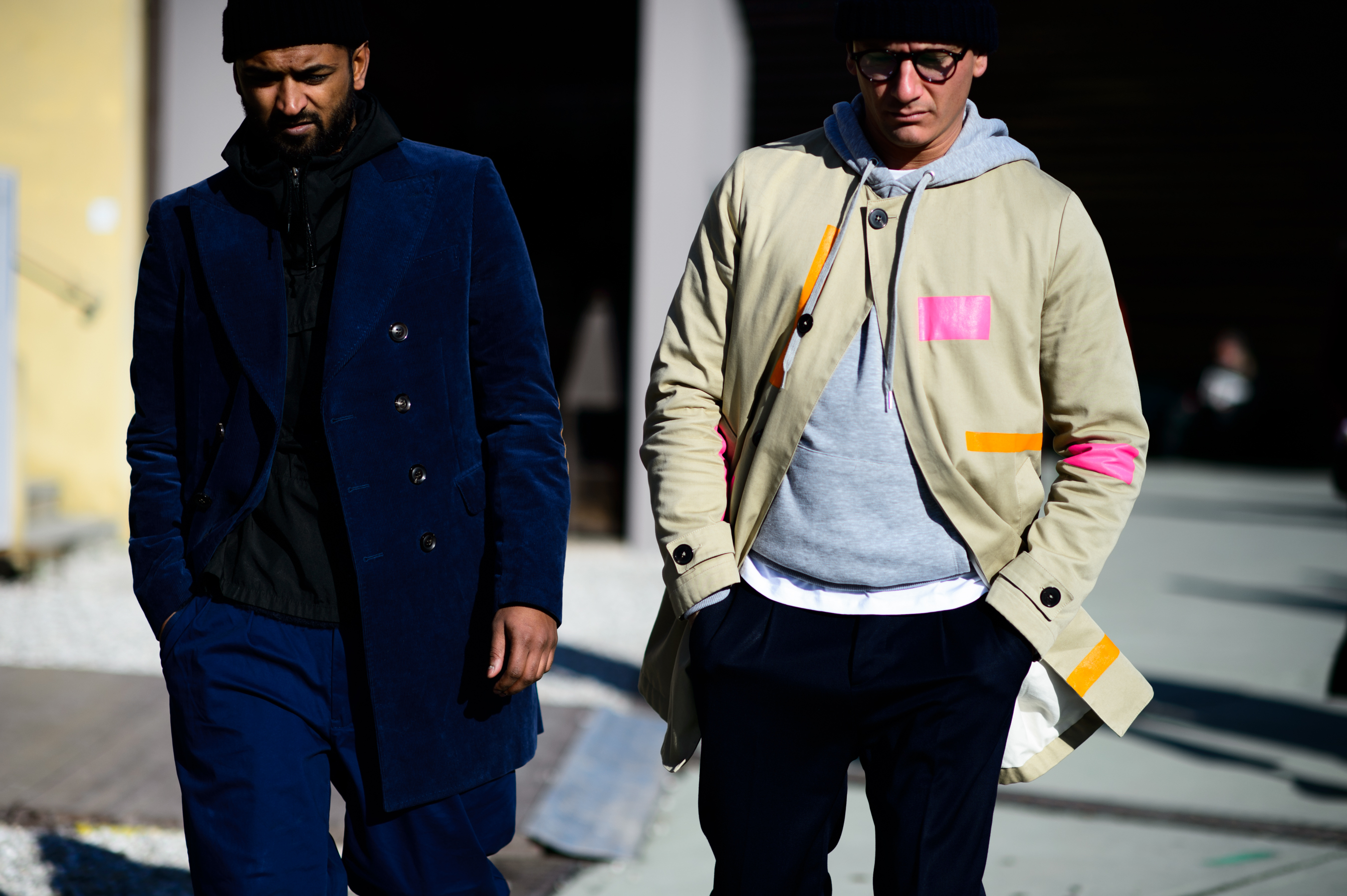 Two men wearing short coats