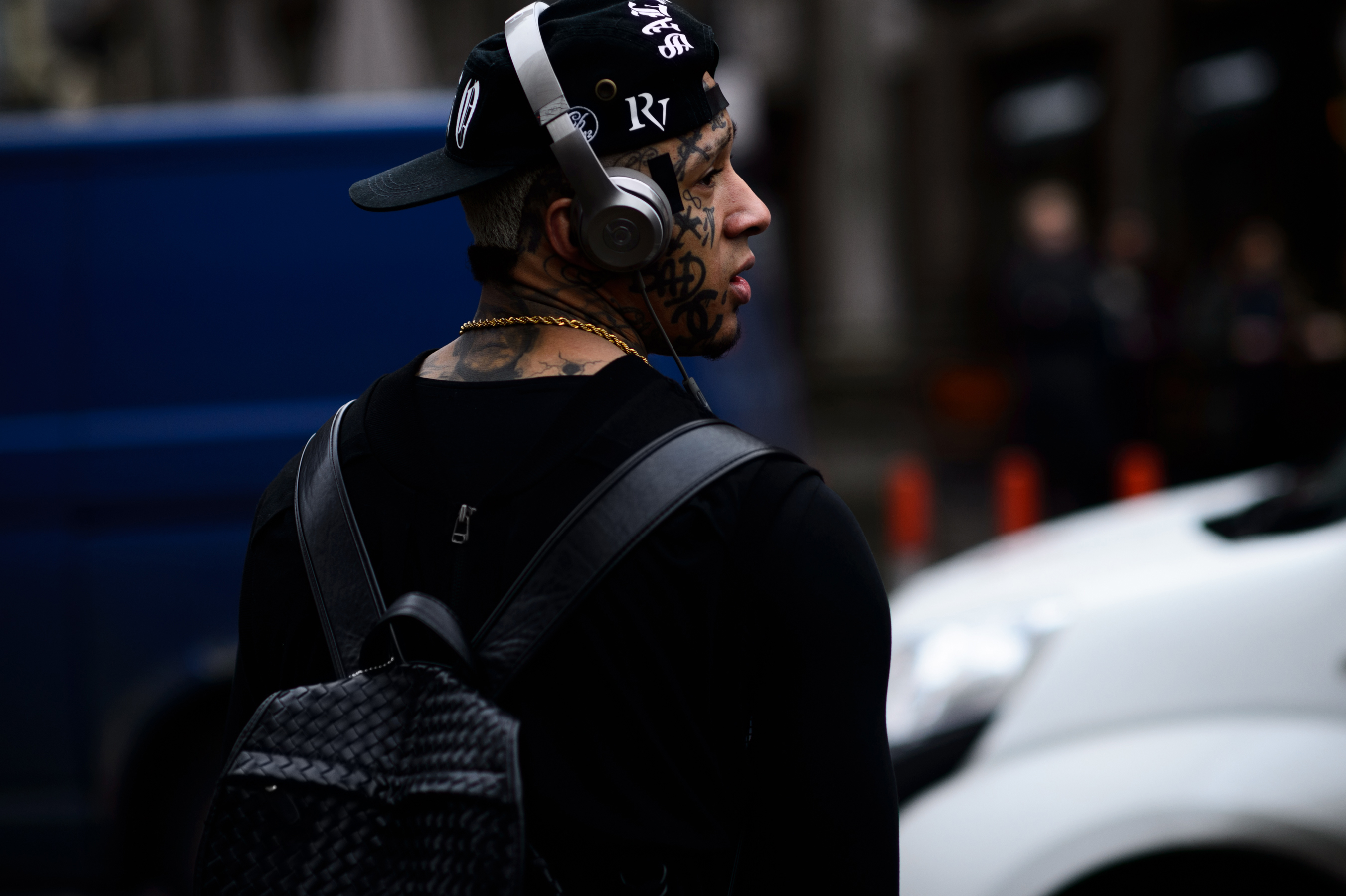 Man with tattooed face wearing Beats by Dre