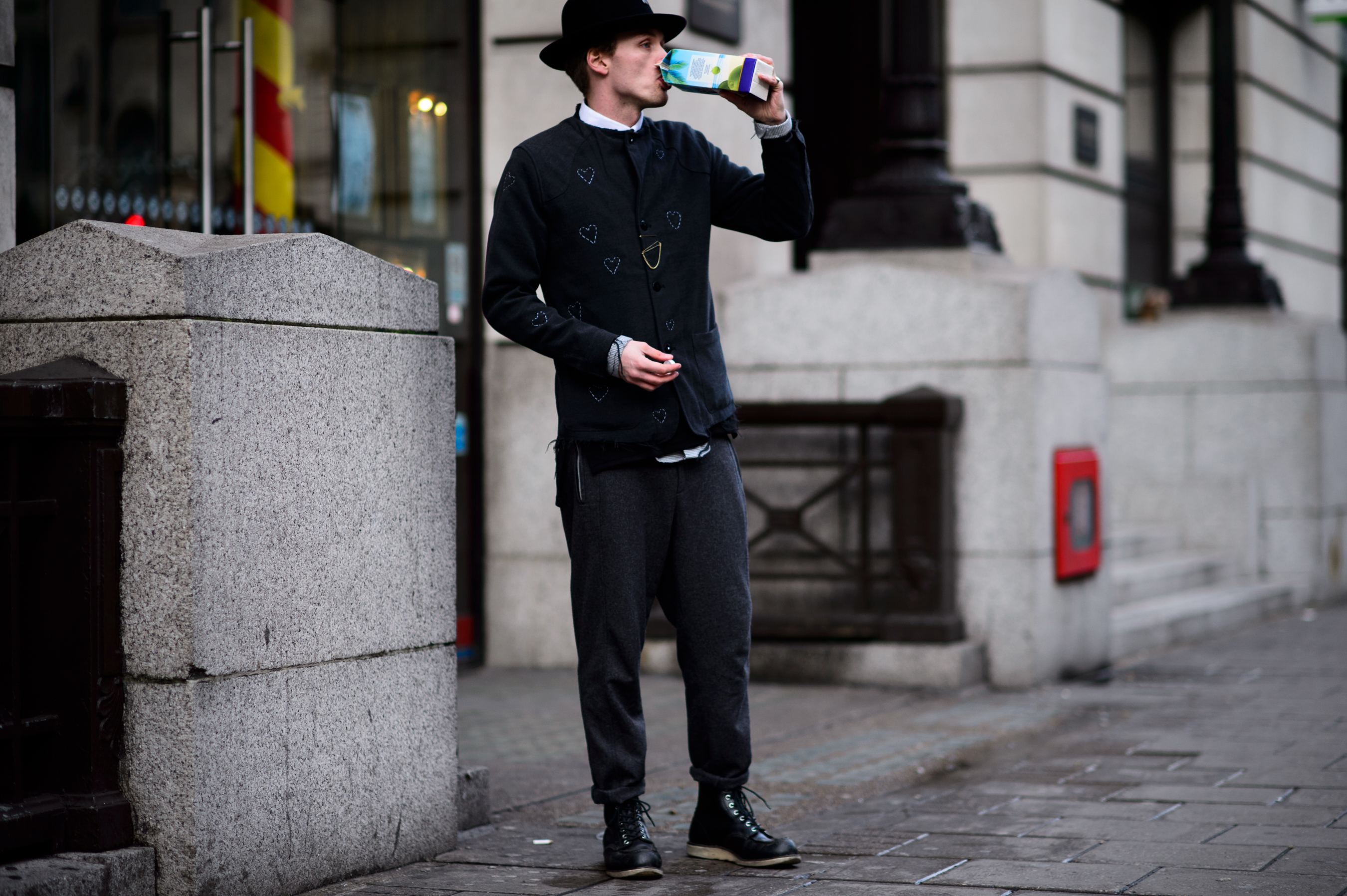 Man in vintage outfit drinking coconut water