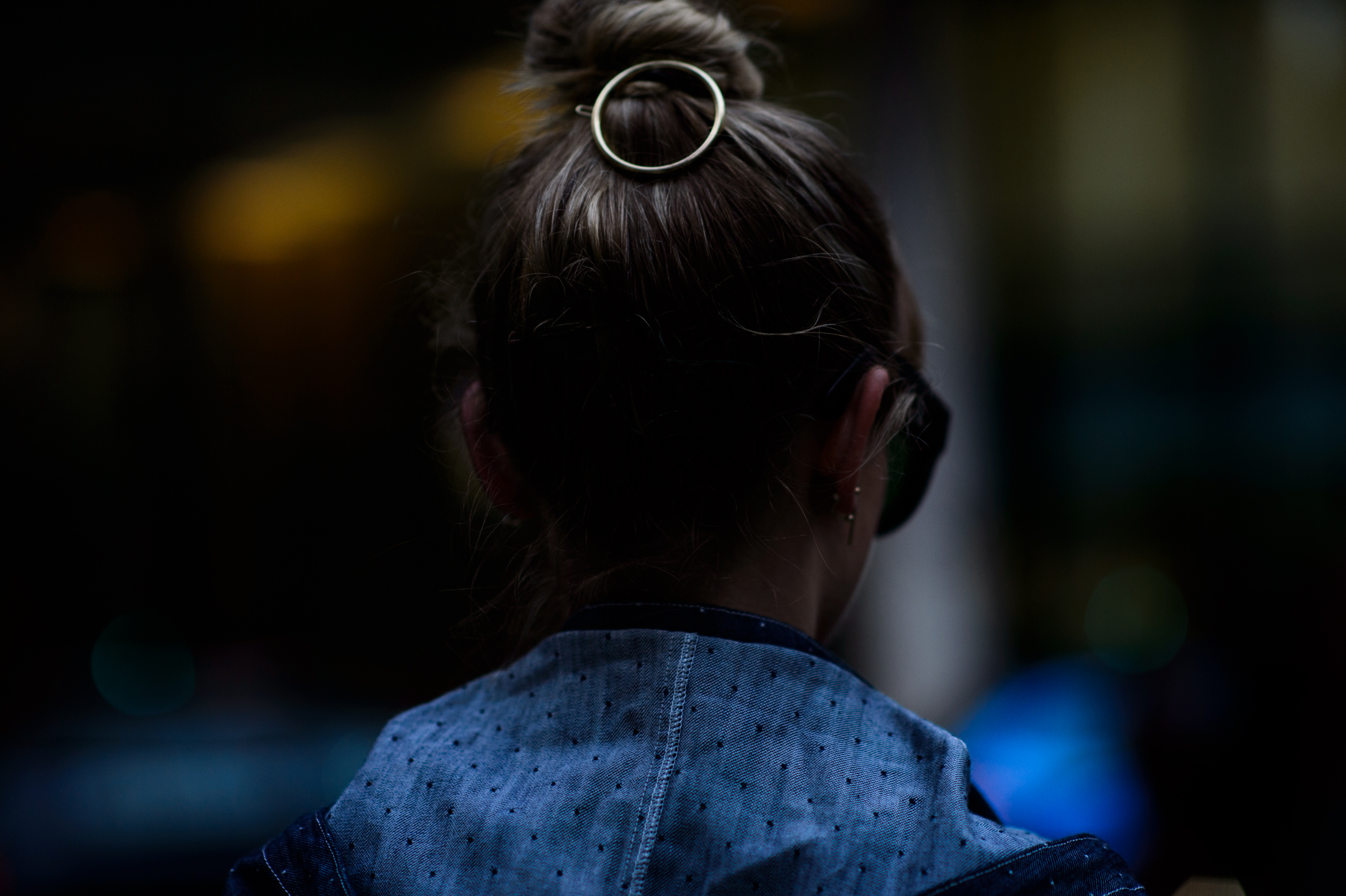 Woman wearing circular shaped hairpiece