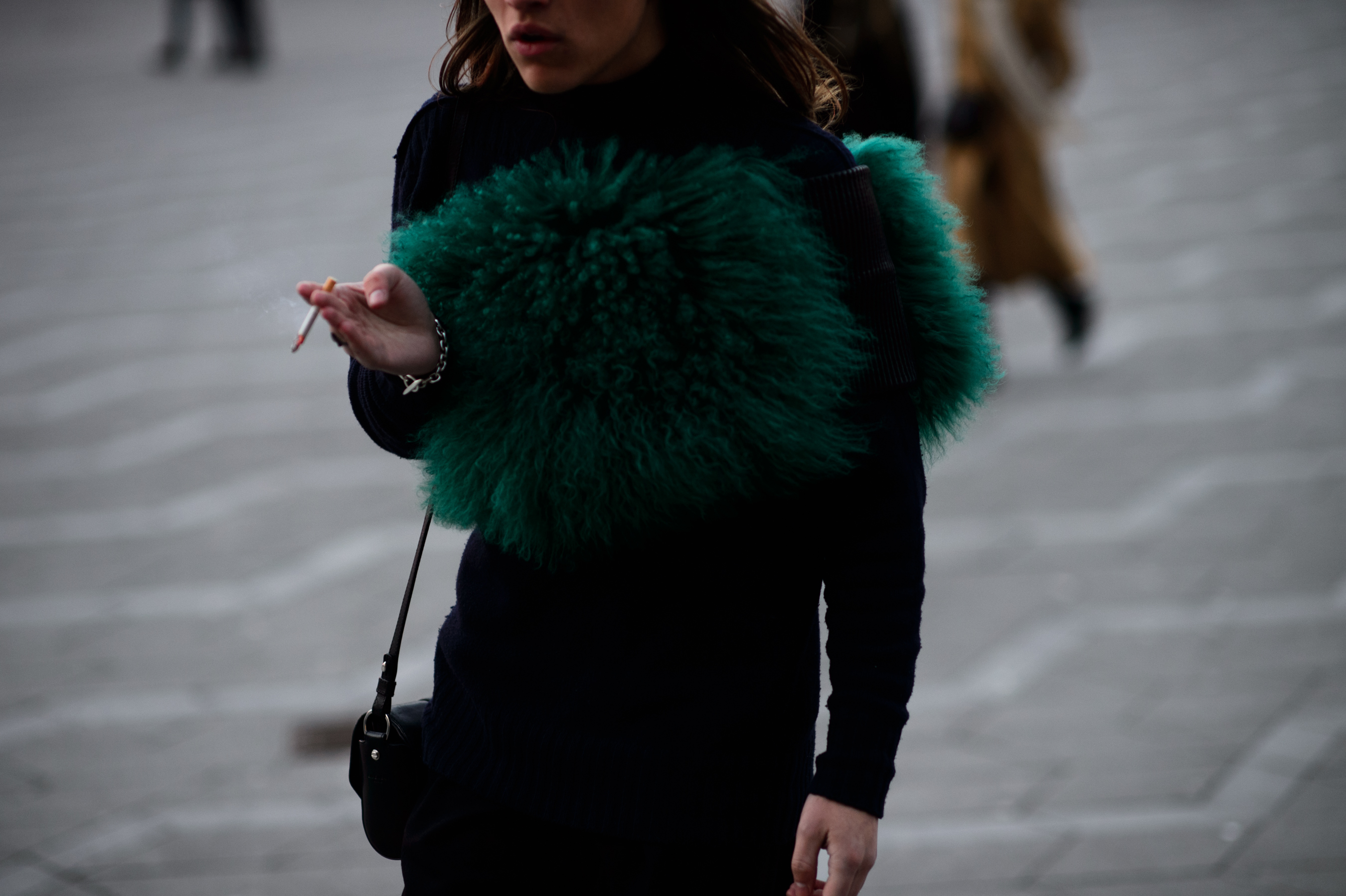 Man wearing green fur scarf