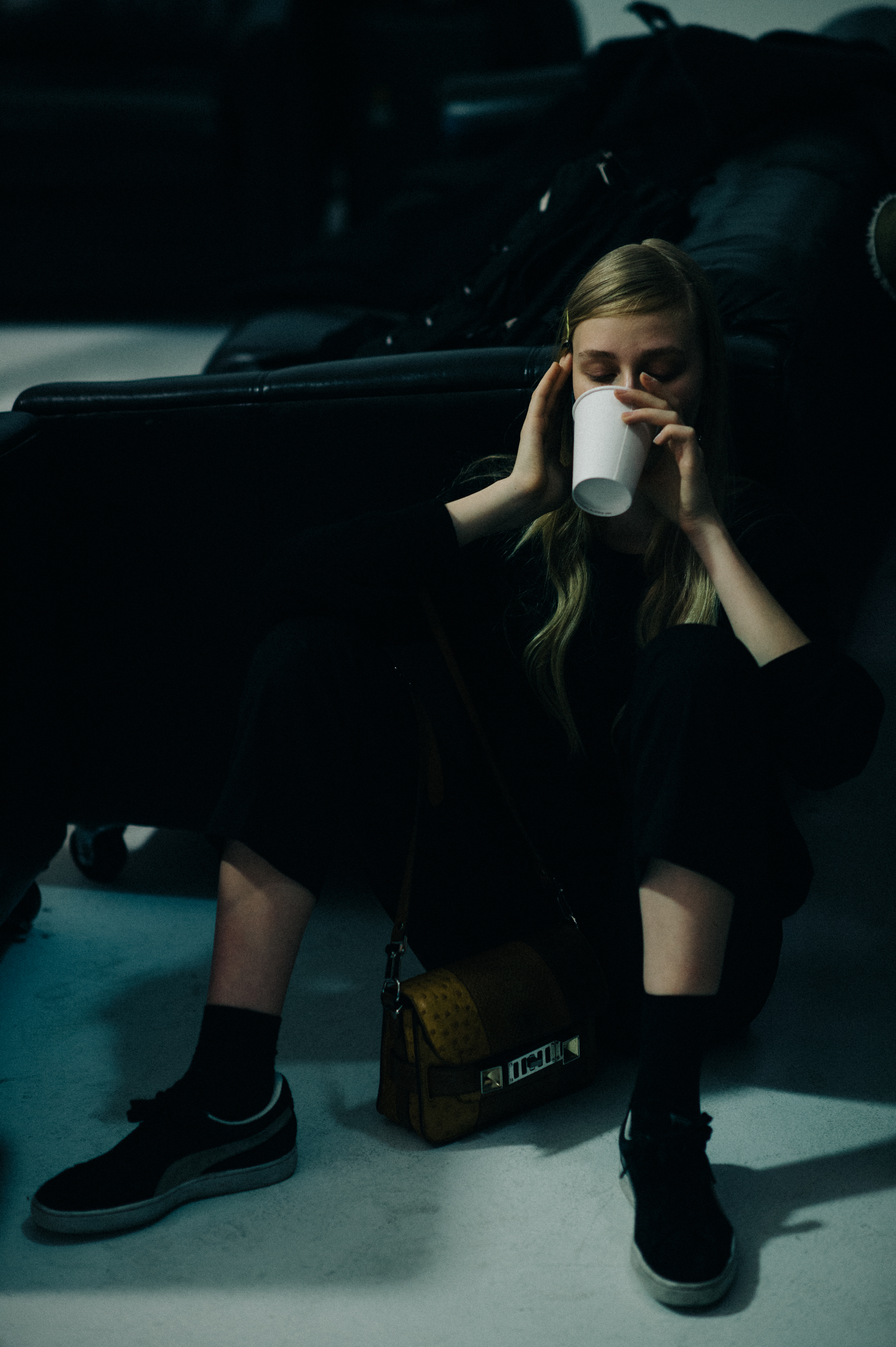 Model drinking coffee on the floor
