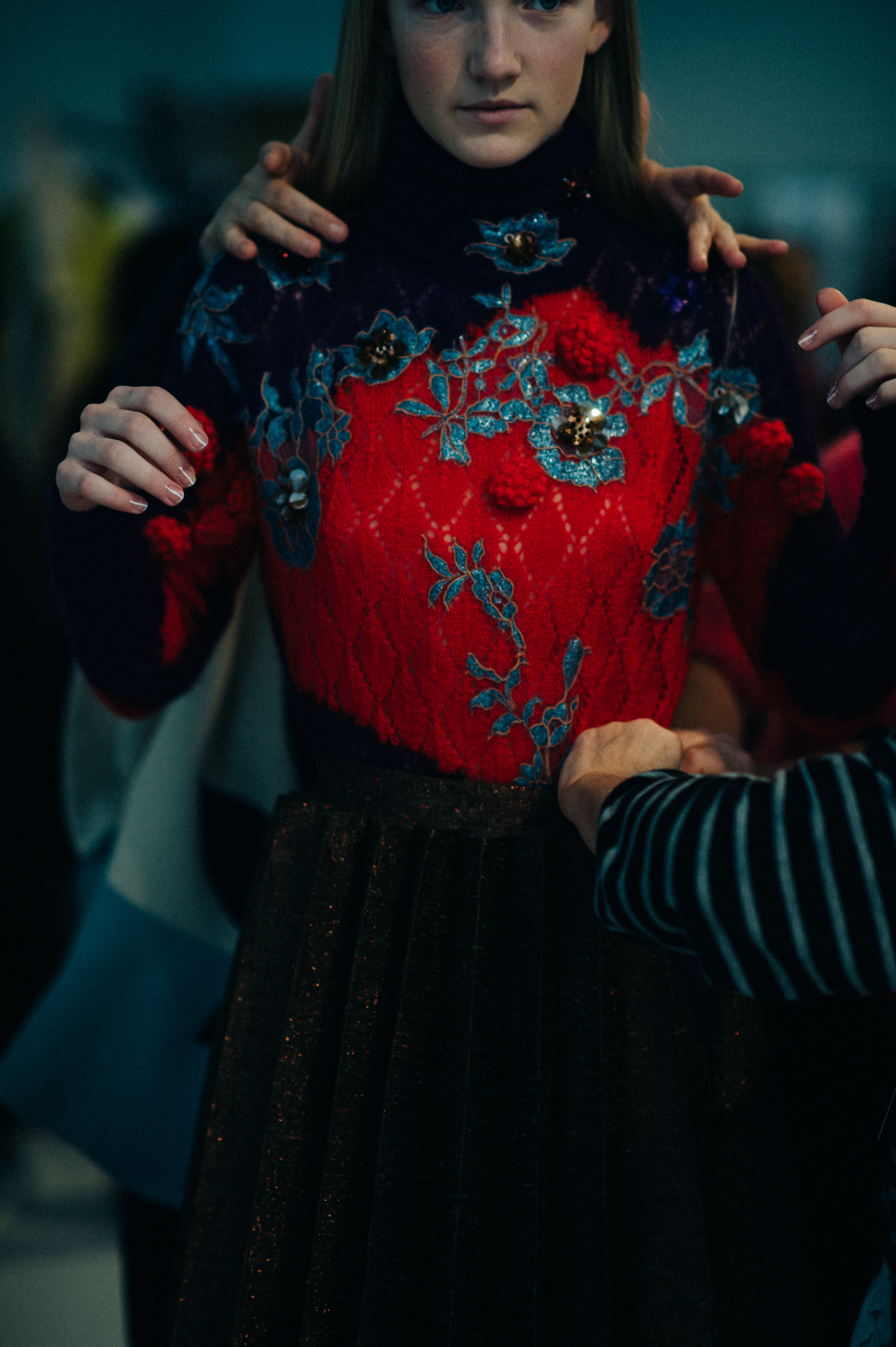 Model getting dressed in red