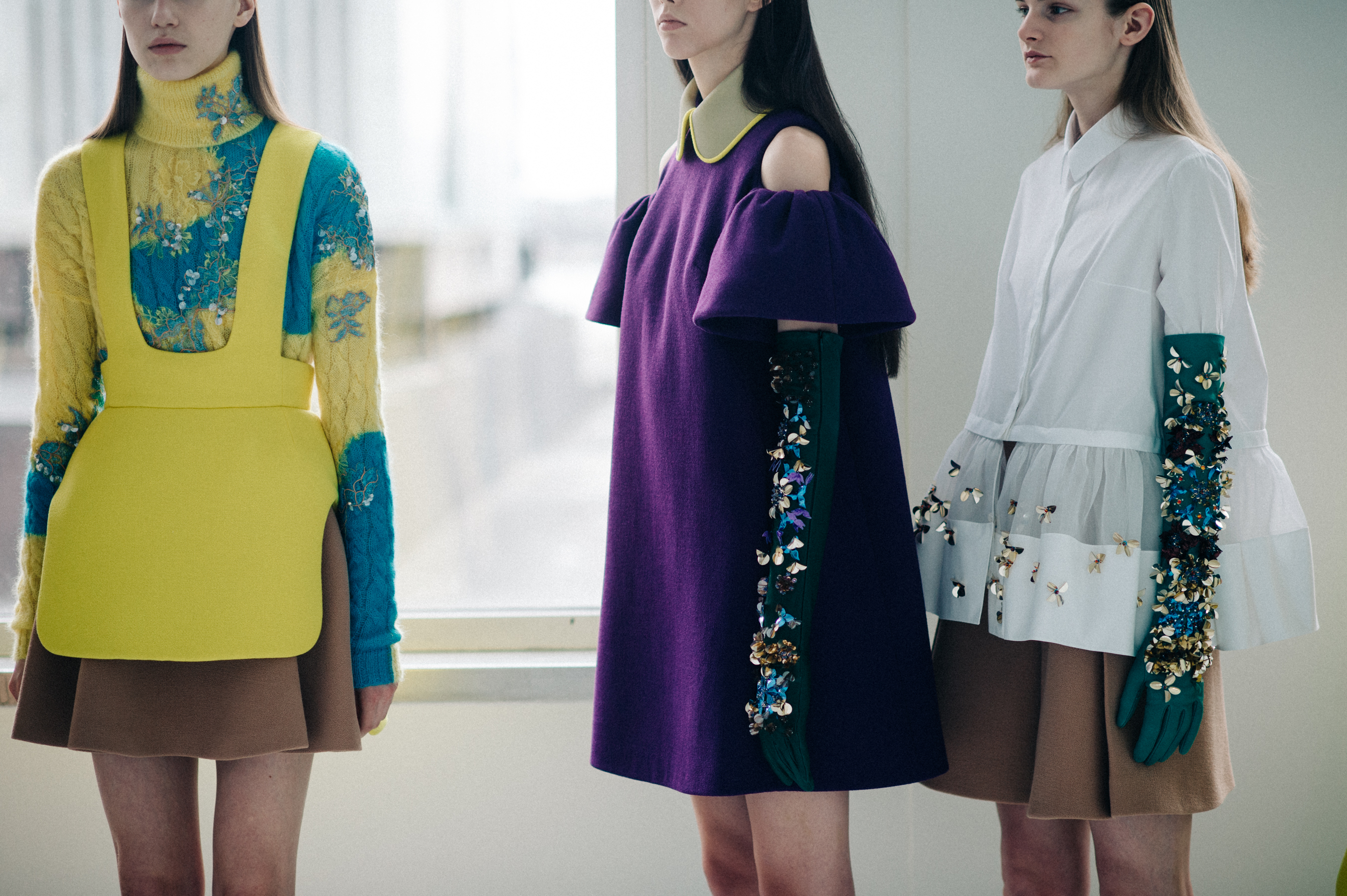 Three models lined up dressed