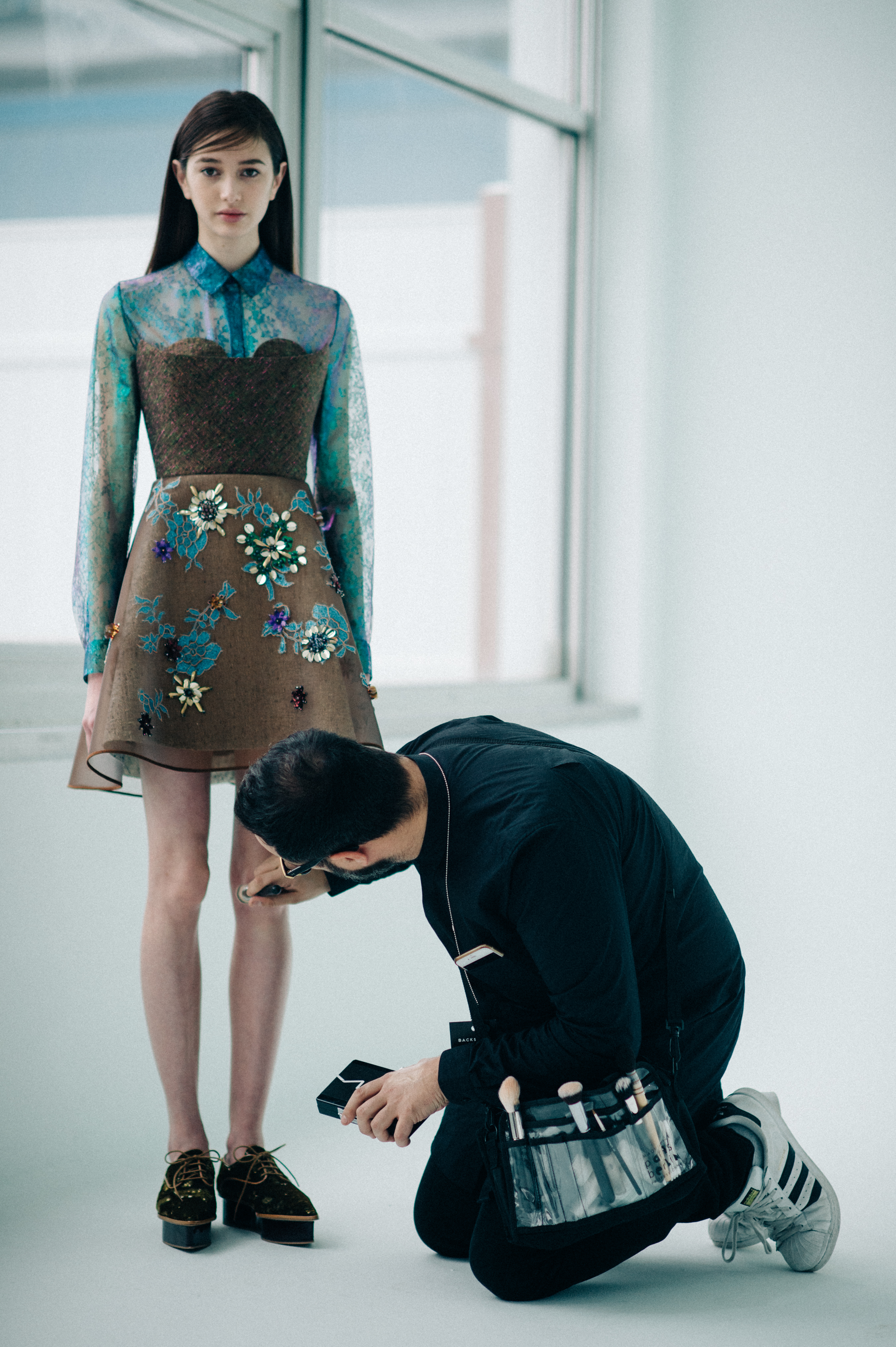 Model getting legs touched up