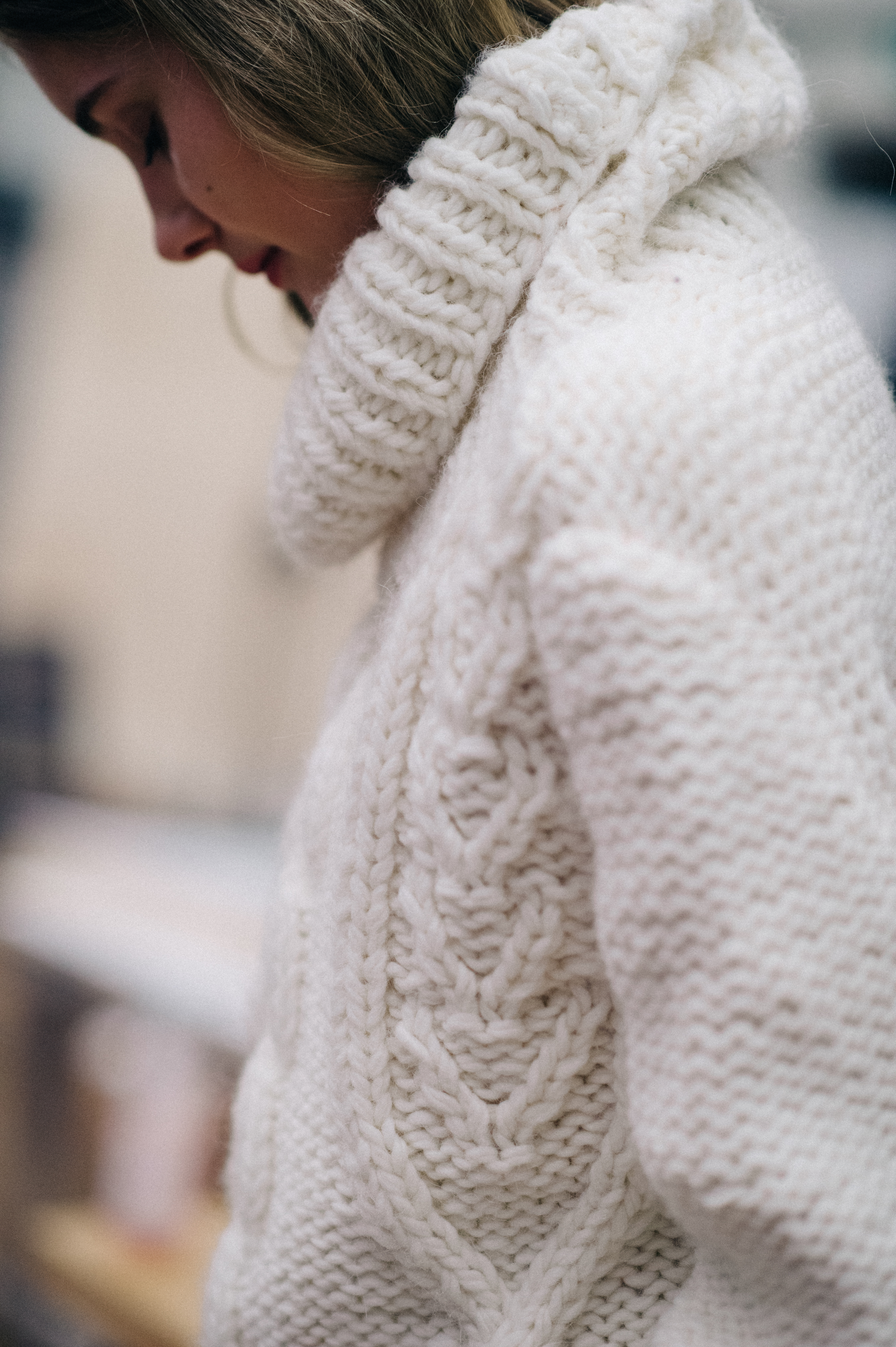 Model wearing white sweater