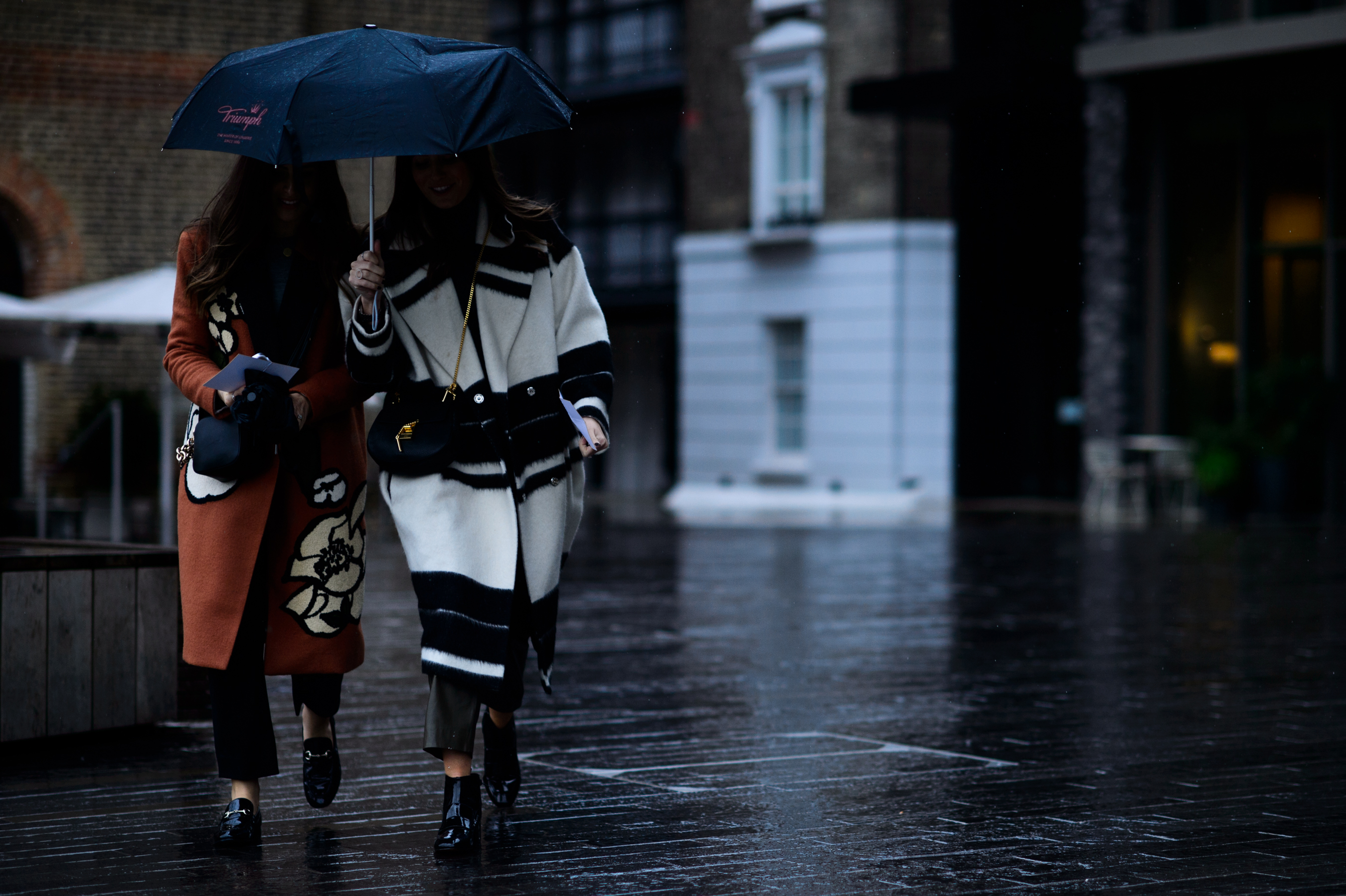 Two women under umbrella