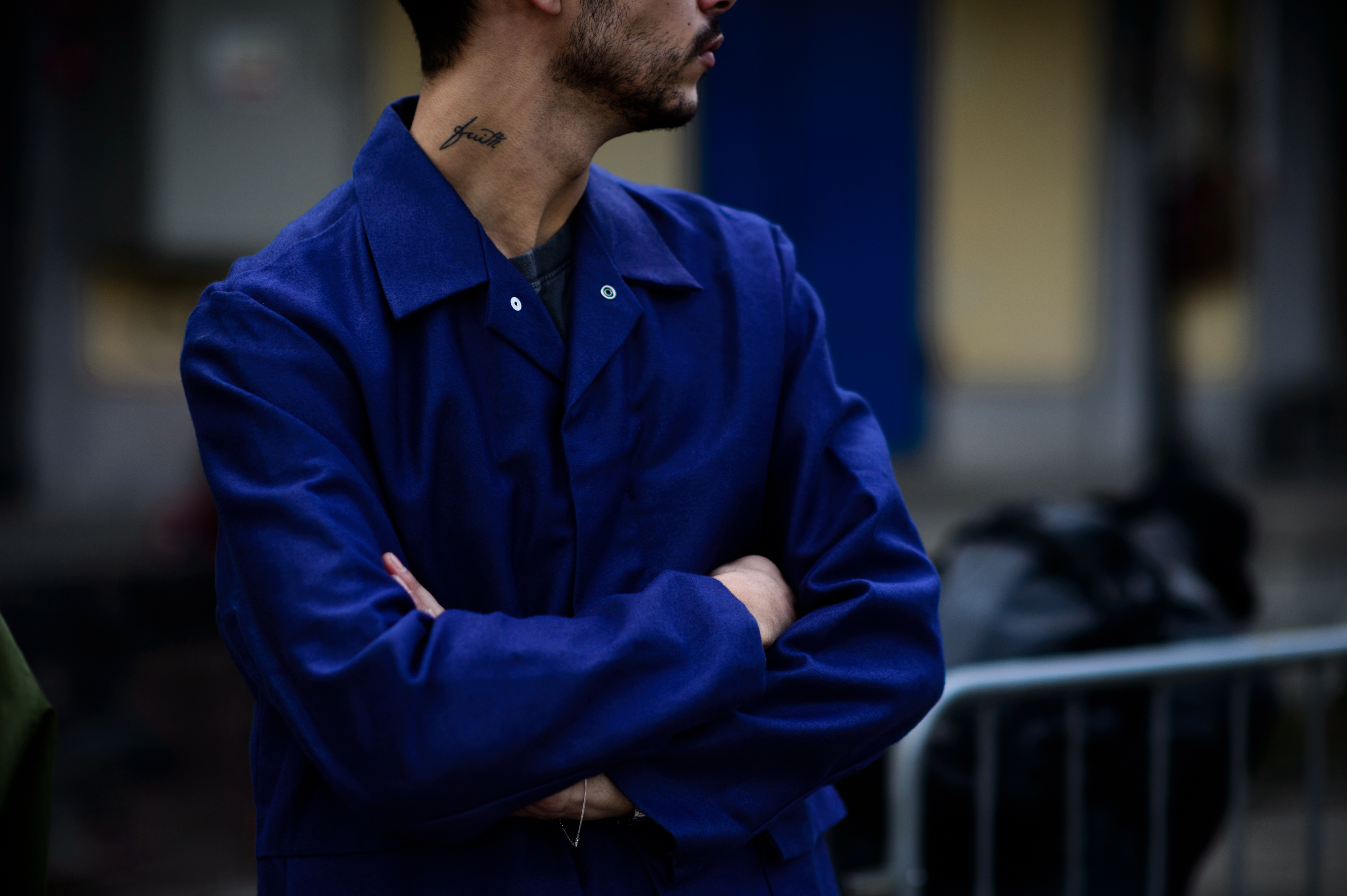 Man with blue shirt and tattoo