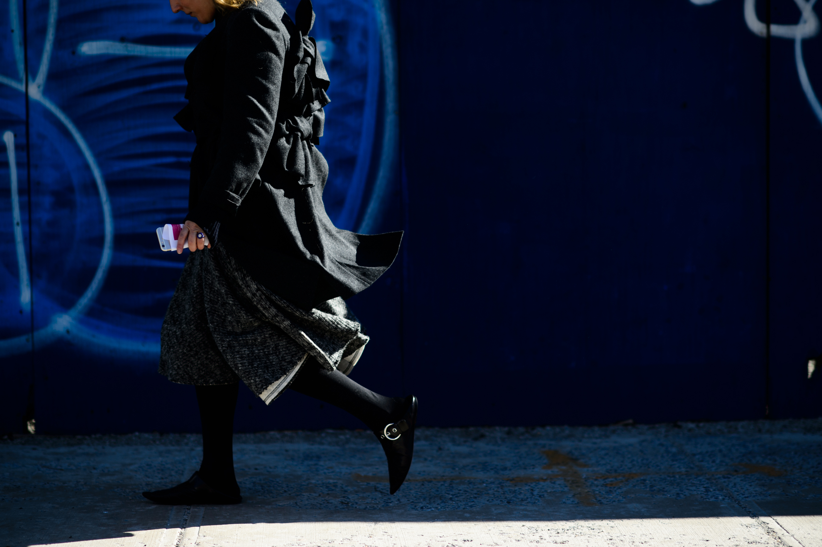 Woman wearing coat with ribbons