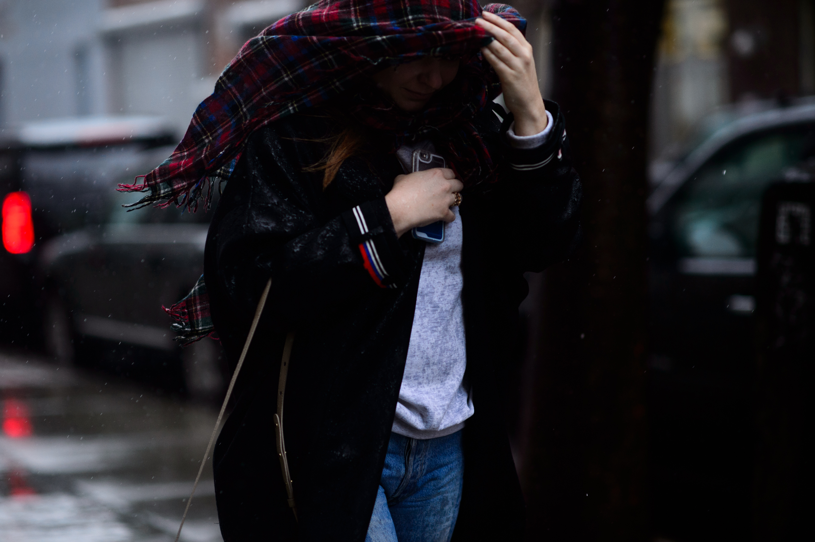 Woman covering head in rain