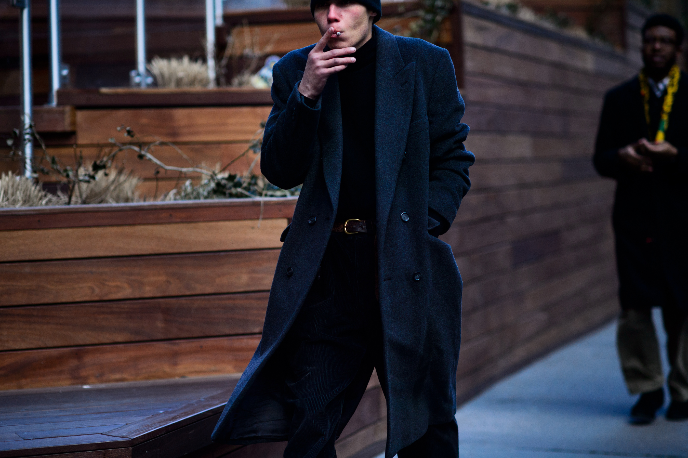 Man wearing coat smoking