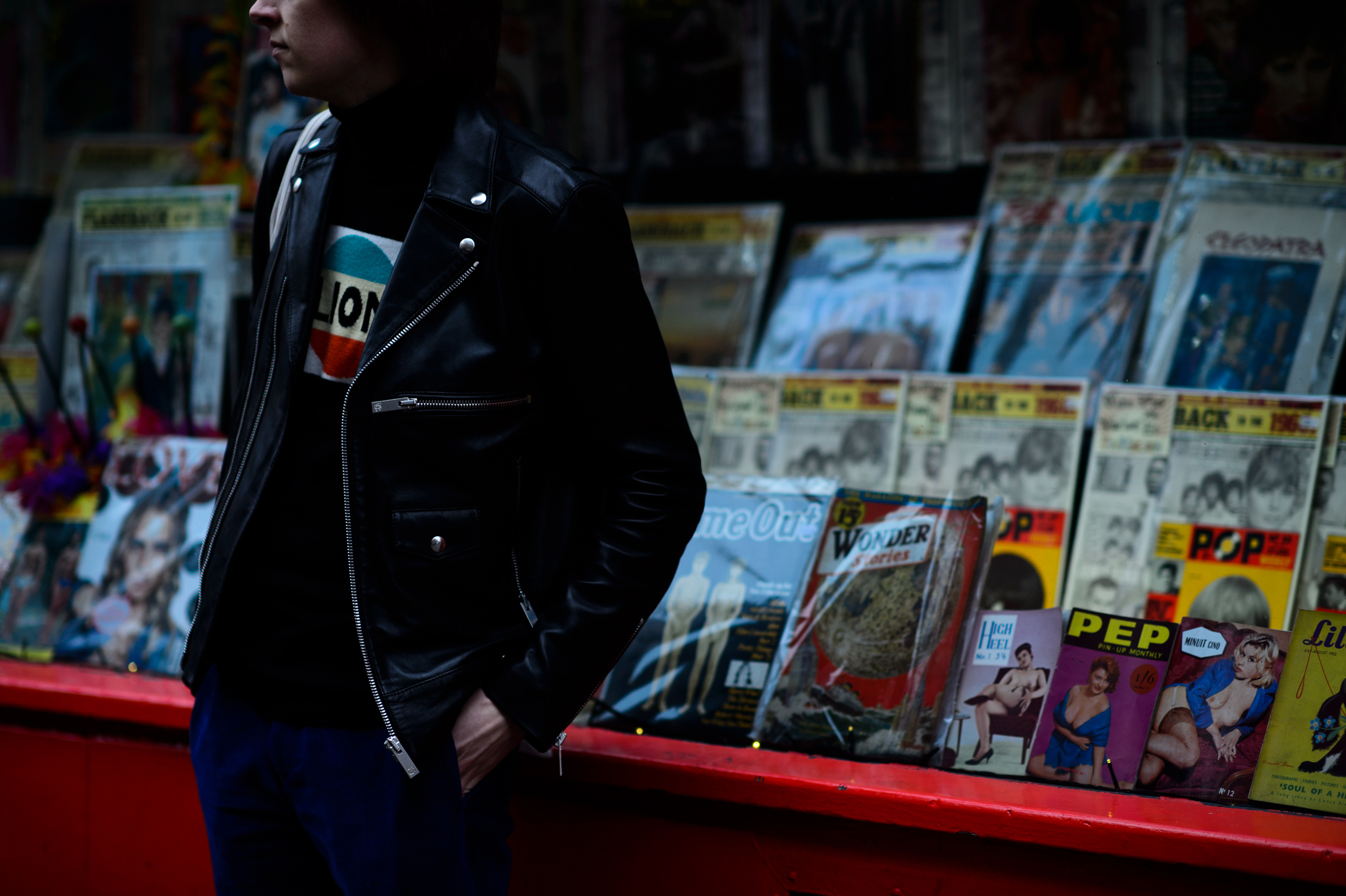 Man in front of magazine stand