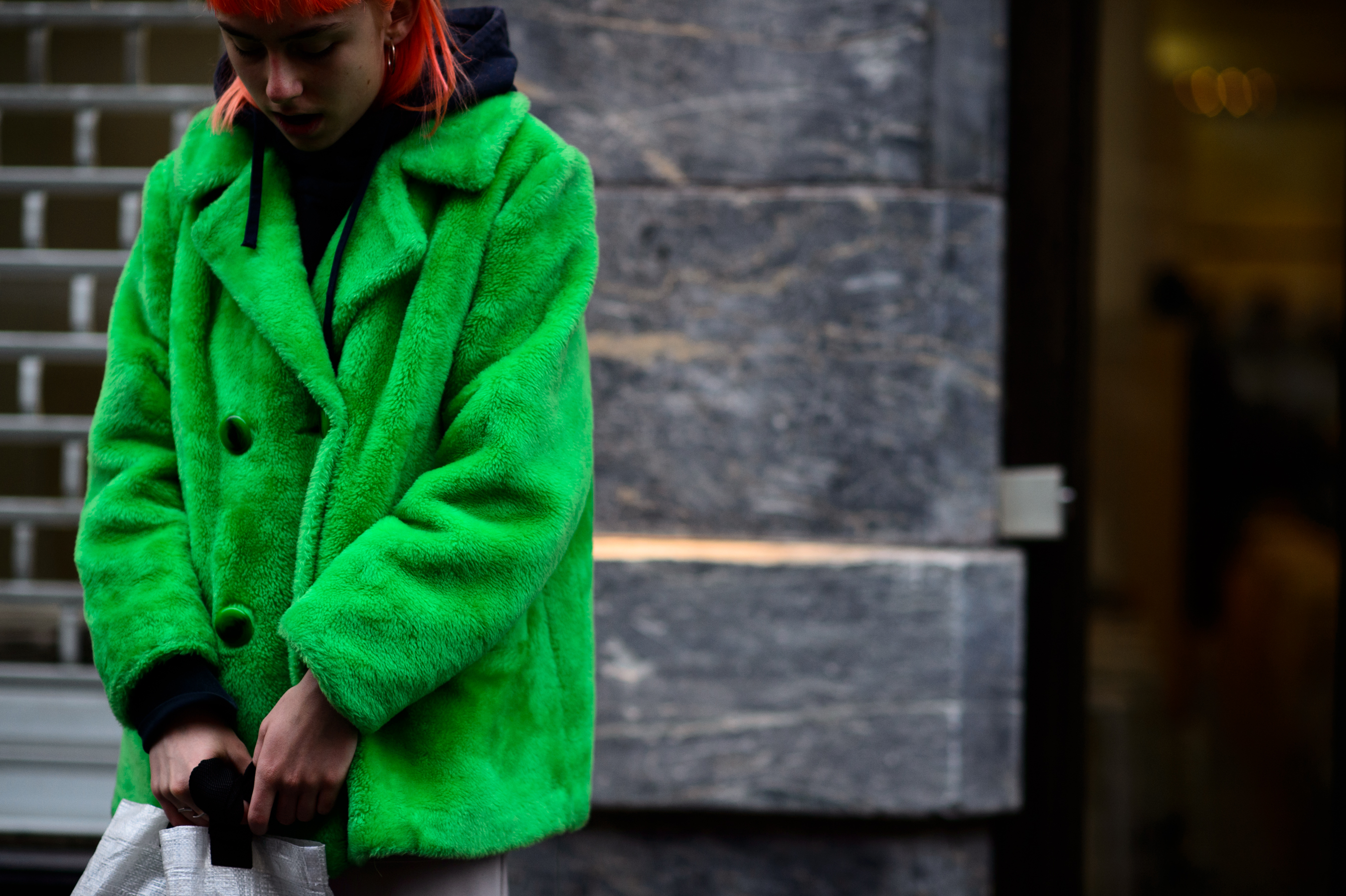 Orange hair editor in green fur coat
