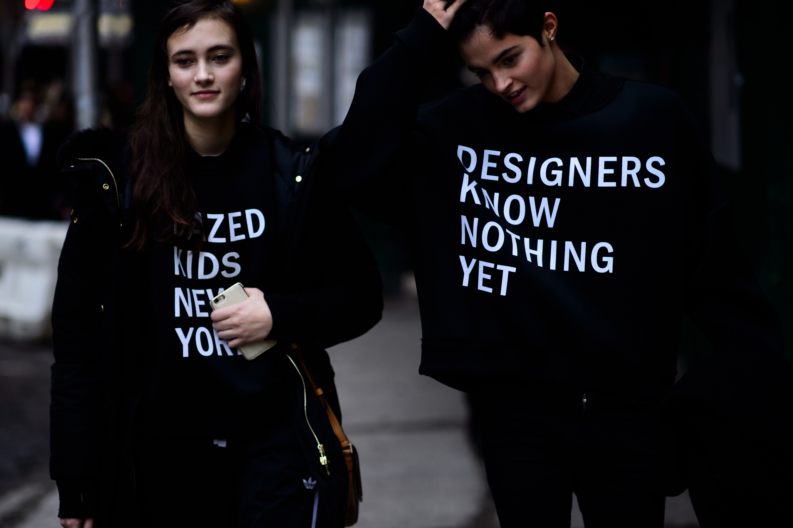 Two models wearing DNKY sweatshirts