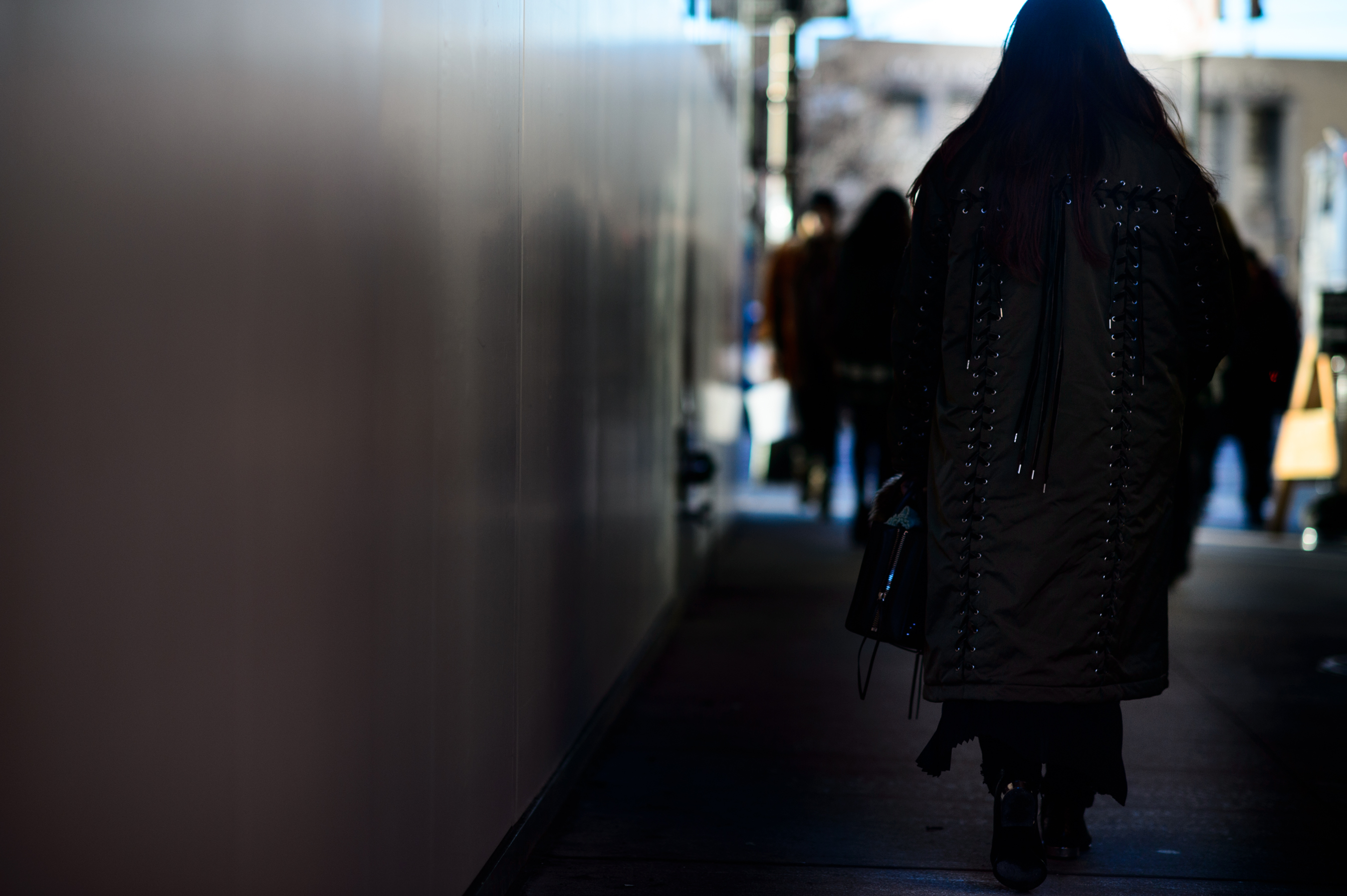 Woman wearing big stitched coat