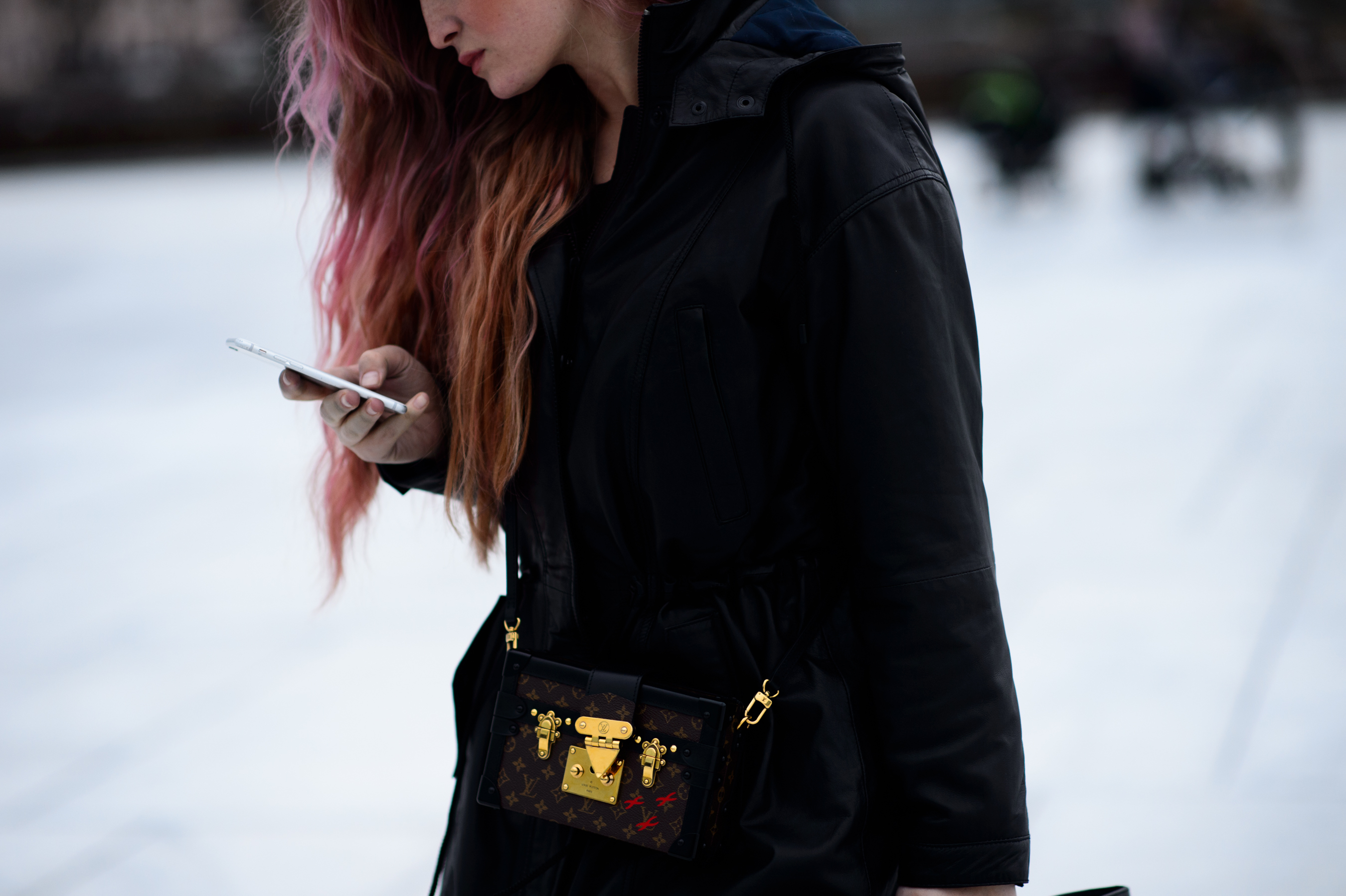 Pink hair woman with iphone and Louis Vuitton minaudiere